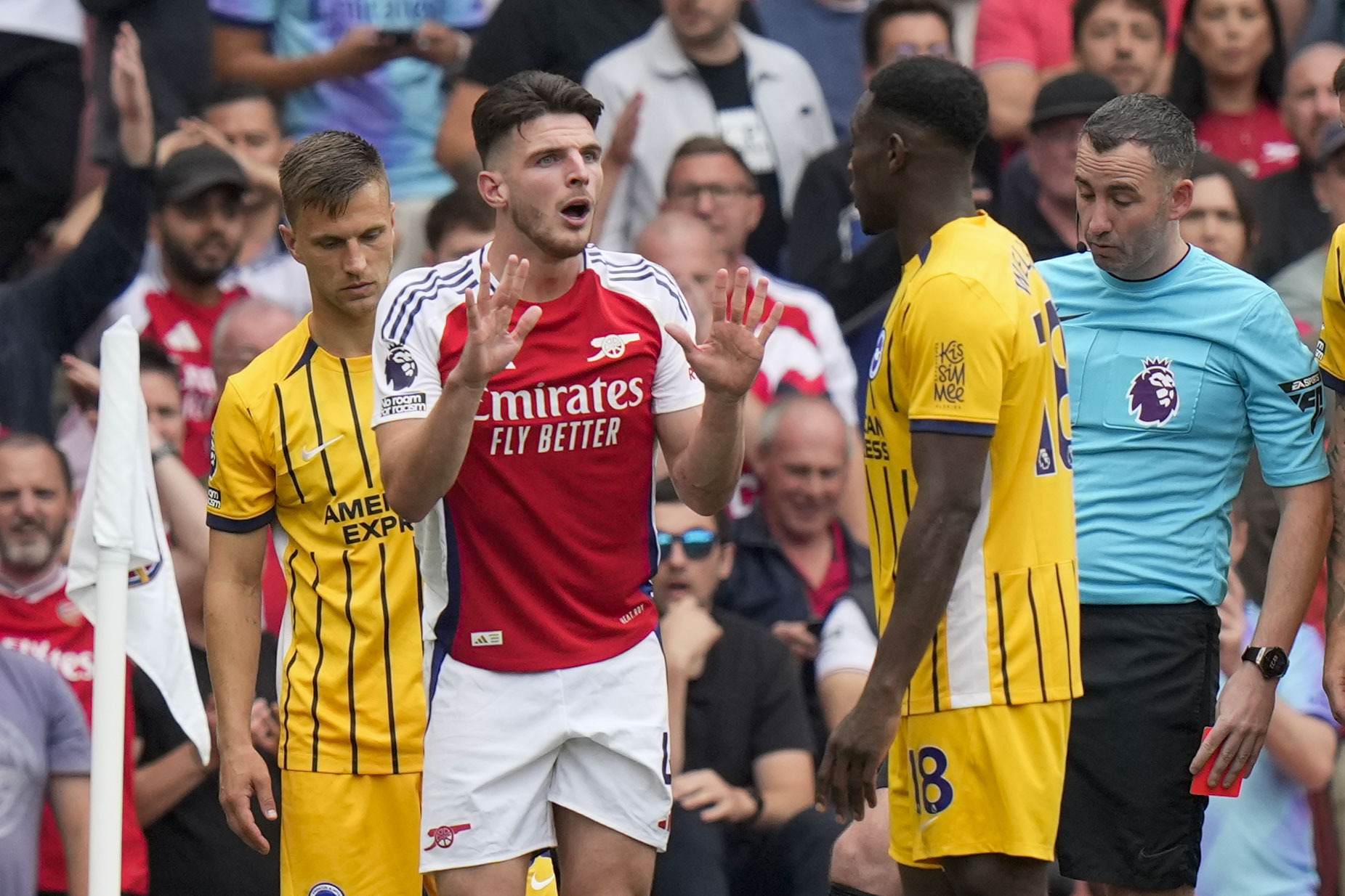 Arsenal's Declan Rice, left, discusses with Brighton's Danny Welbeck during the English Premier League soccer match between Arsenal and Brighton, at Emirates Stadium in London, Saturday, Aug. 31, 2024. 