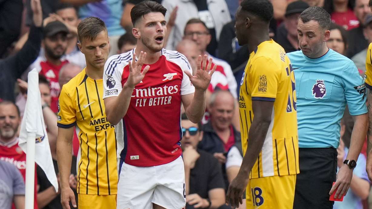 Arsenal's Declan Rice, left, discusses with Brighton's Danny Welbeck during the English Premier League soccer match between Arsenal and Brighton, at Emirates Stadium in London, Saturday, Aug. 31, 2024.