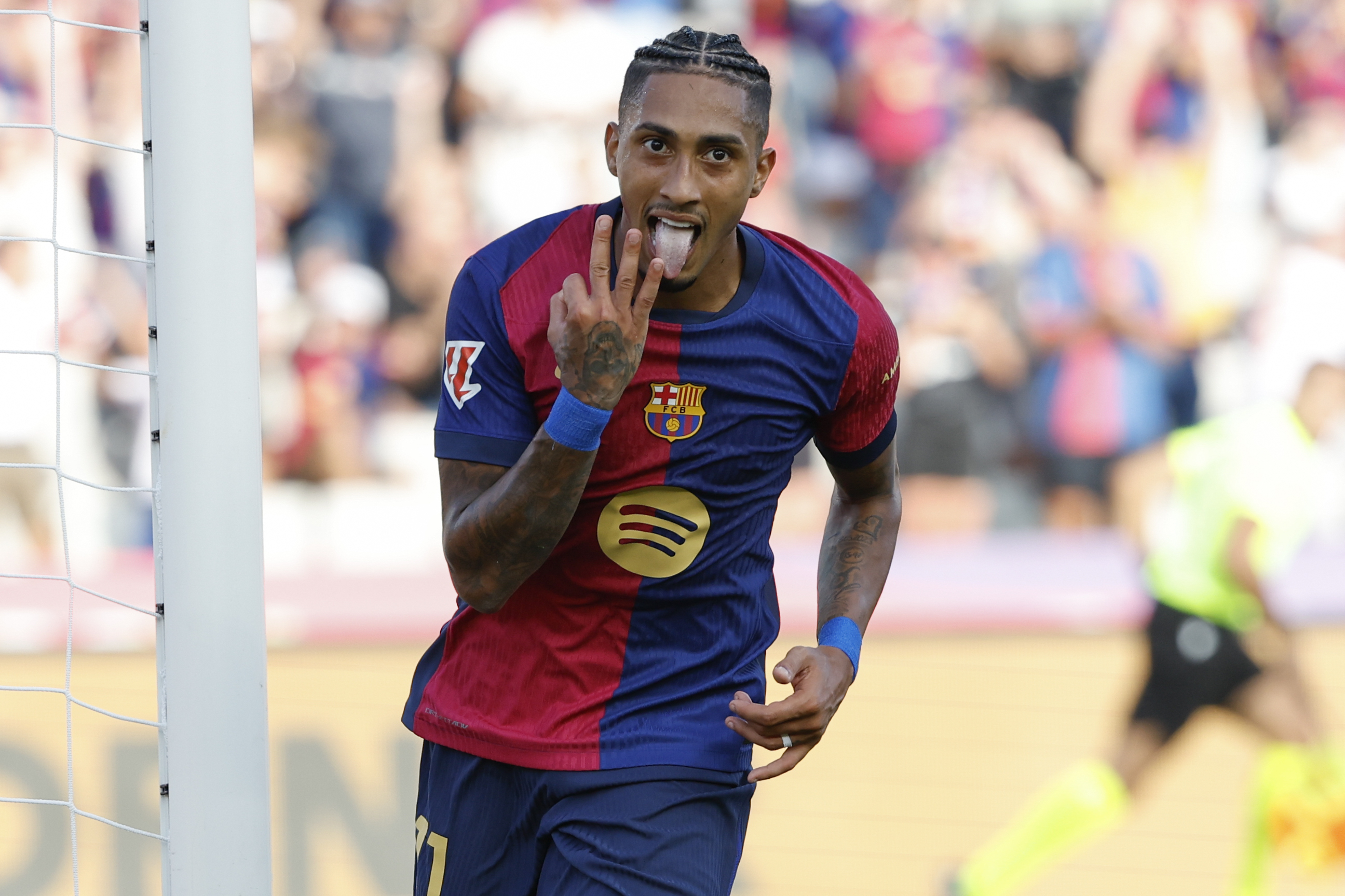 Barcelona's Raphinha celebrates scoring his side's 5th goal during the Spanish La Liga soccer match between FC Barcelona and Valladolid at the Olympic stadium in Barcelona, Spain, Saturday, Aug. 31, 2024. 