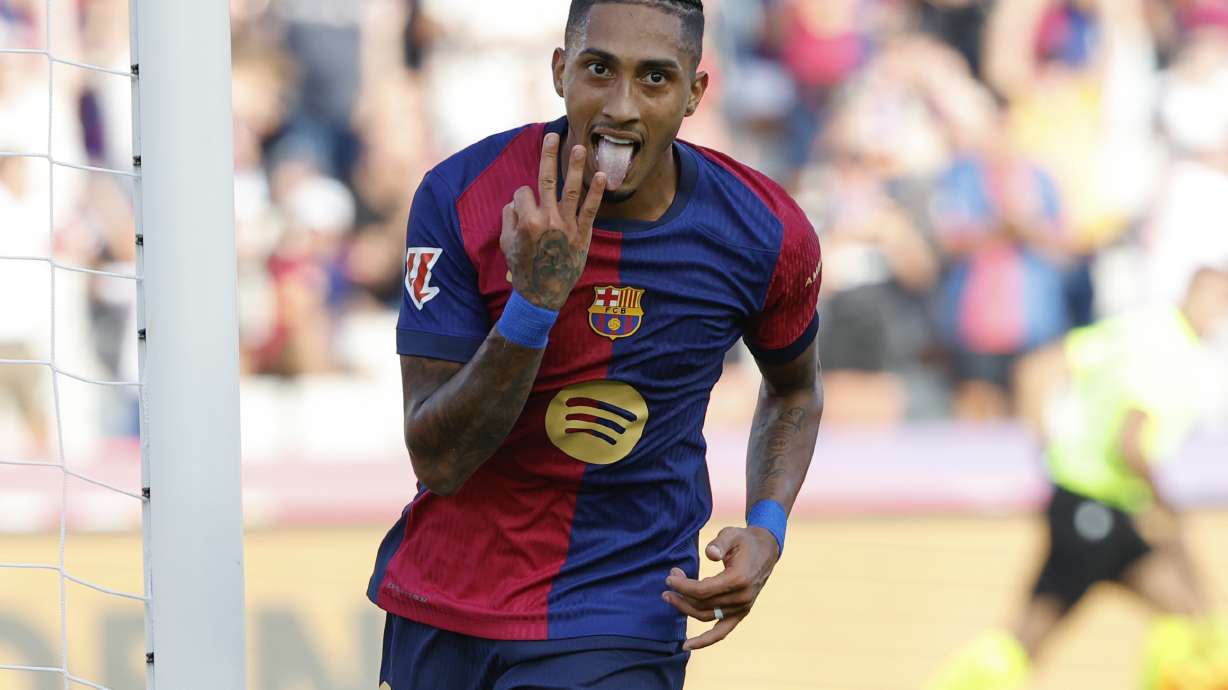 Barcelona's Raphinha celebrates scoring his side's 5th goal during the Spanish La Liga soccer match between FC Barcelona and Valladolid at the Olympic stadium in Barcelona, Spain, Saturday, Aug. 31, 2024.