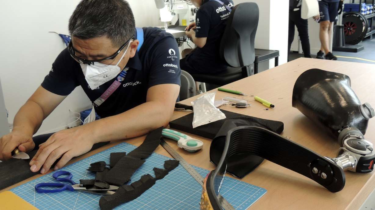 An Ottobock employee works in the Ottobock repair center at the Paralympic Village in Saint-Denis, near Paris, France, Saturday, Aug. 24, 2024.