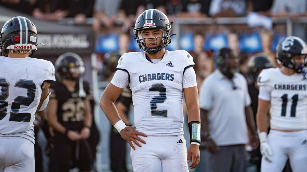 Corner Canyon quarterback Helaman Casuga looks to the sidelines during a game against Lone Peak on Aug. 30, 2024.