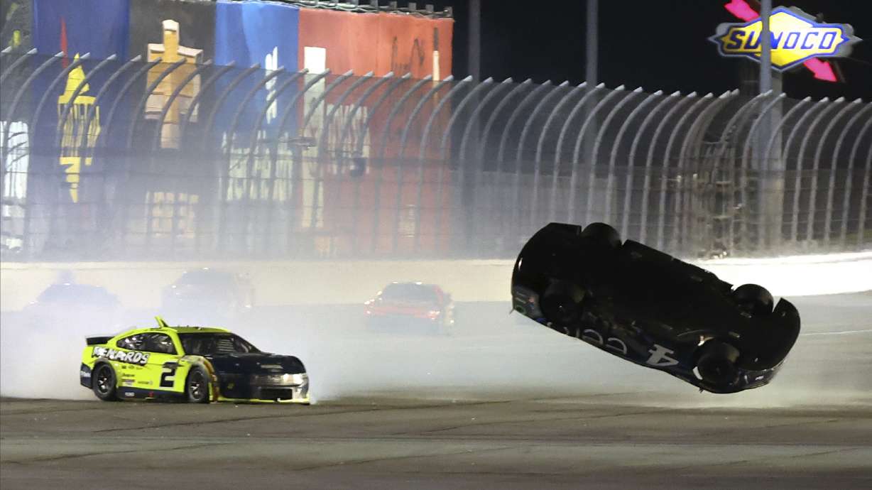 Josh Berry's (4) car flips in the air after getting involved in a multi-car collision on the back stretch during a NASCAR Cup Series auto race at Daytona International Speedway, Saturday, Aug. 24, 2024, in Daytona Beach, Fla.