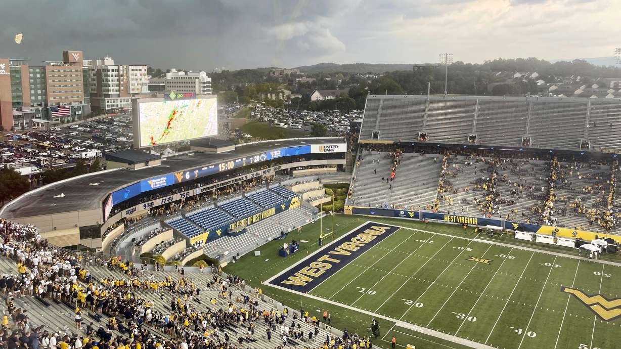Storm clouds are shown over the stadium at halftime Saturday, Aug. 31, 2024, at the game between No. 8 Penn State and West Virginia in Morgantown, W.Va. Lightning forced the second half of the game to be delayed for several hours.