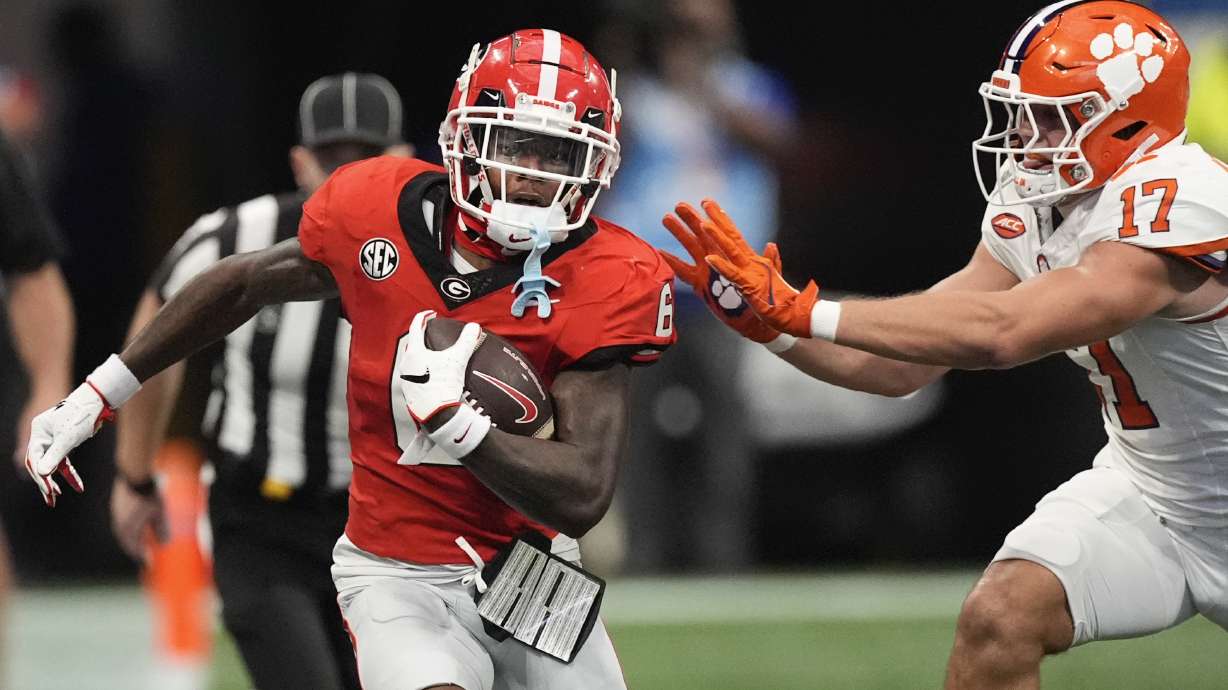 Georgia wide receiver Dominic Lovett (6) is pushed out of bounds by Clemson linebacker Wade Woodaz (17) during the first half of an NCAA college football game Aug. 31, 2024, in Atlanta.