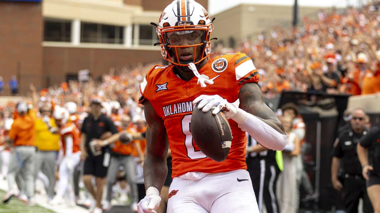 Oklahoma State running back Ollie Gordon II (0) celebrates in the end zone after scoring a touchdown in the first half of an NCAA college football game against South Dakota State, Saturday, Aug. 31, 2024, in Stillwater, Okla.