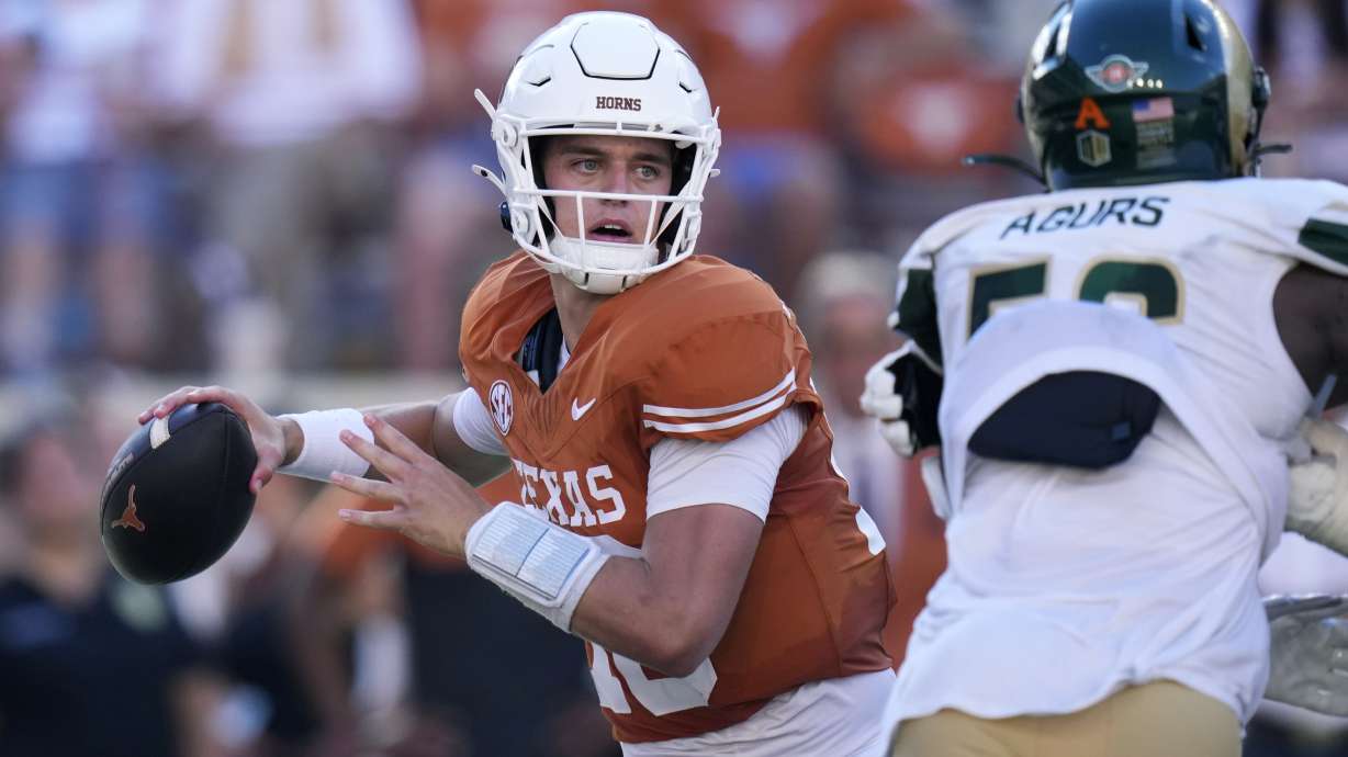 Texas quarterback Arch Manning, left, throws against Colorado State during the second half of an NCAA college football game in Austin, Texas, Saturday, Aug. 31, 2024.