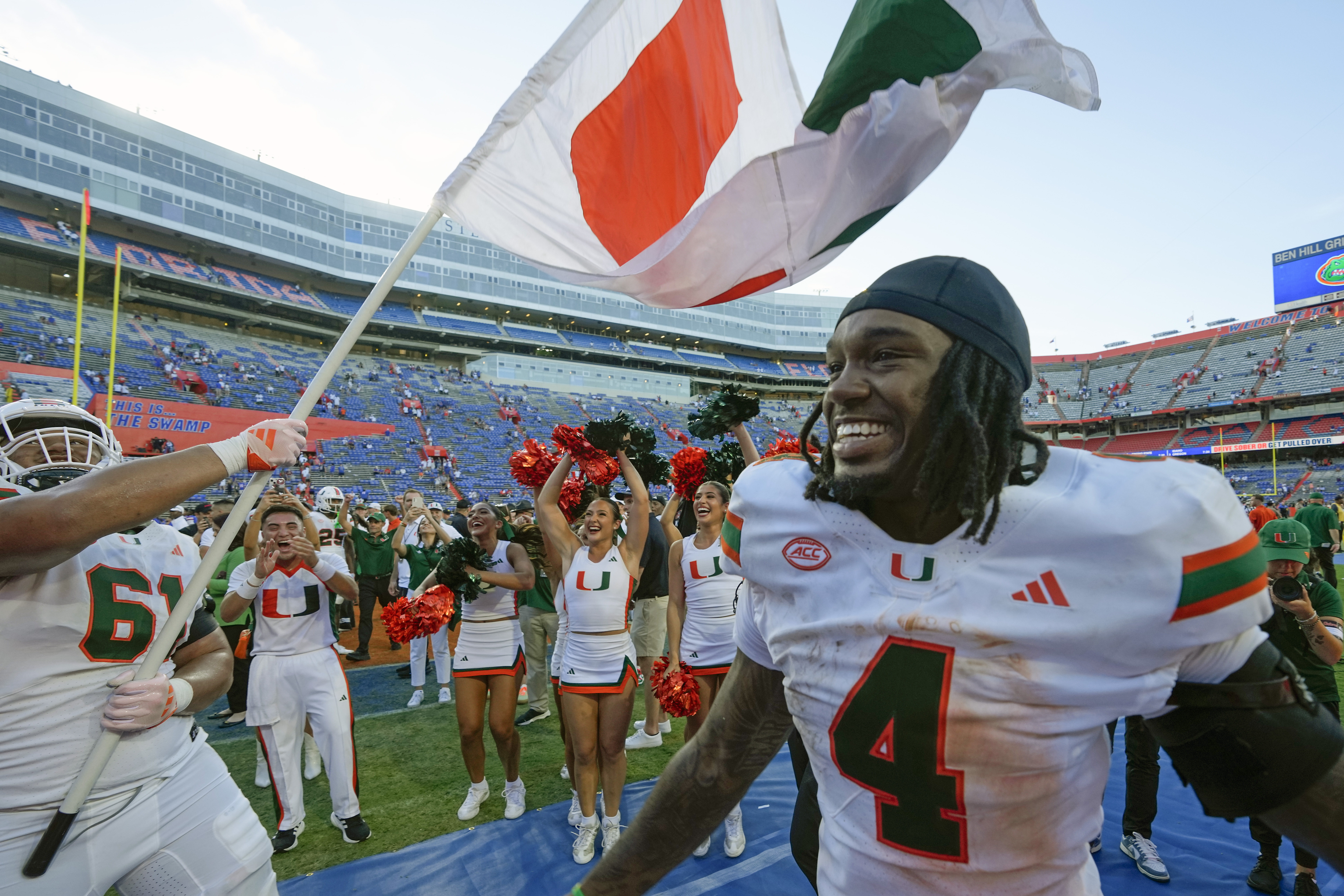 Miami offensive lineman Francis Mauigoa (61) and running back Mark Fletcher Jr. (4) celebrate after defeating Florida in an NCAA college football game, Saturday, Aug. 31, 2024, in Gainesville, Fla. 