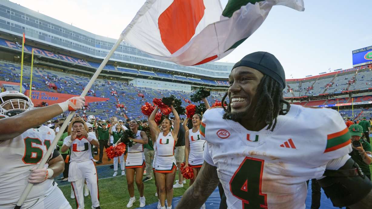 Miami offensive lineman Francis Mauigoa (61) and running back Mark Fletcher Jr. (4) celebrate after defeating Florida in an NCAA college football game, Saturday, Aug. 31, 2024, in Gainesville, Fla.