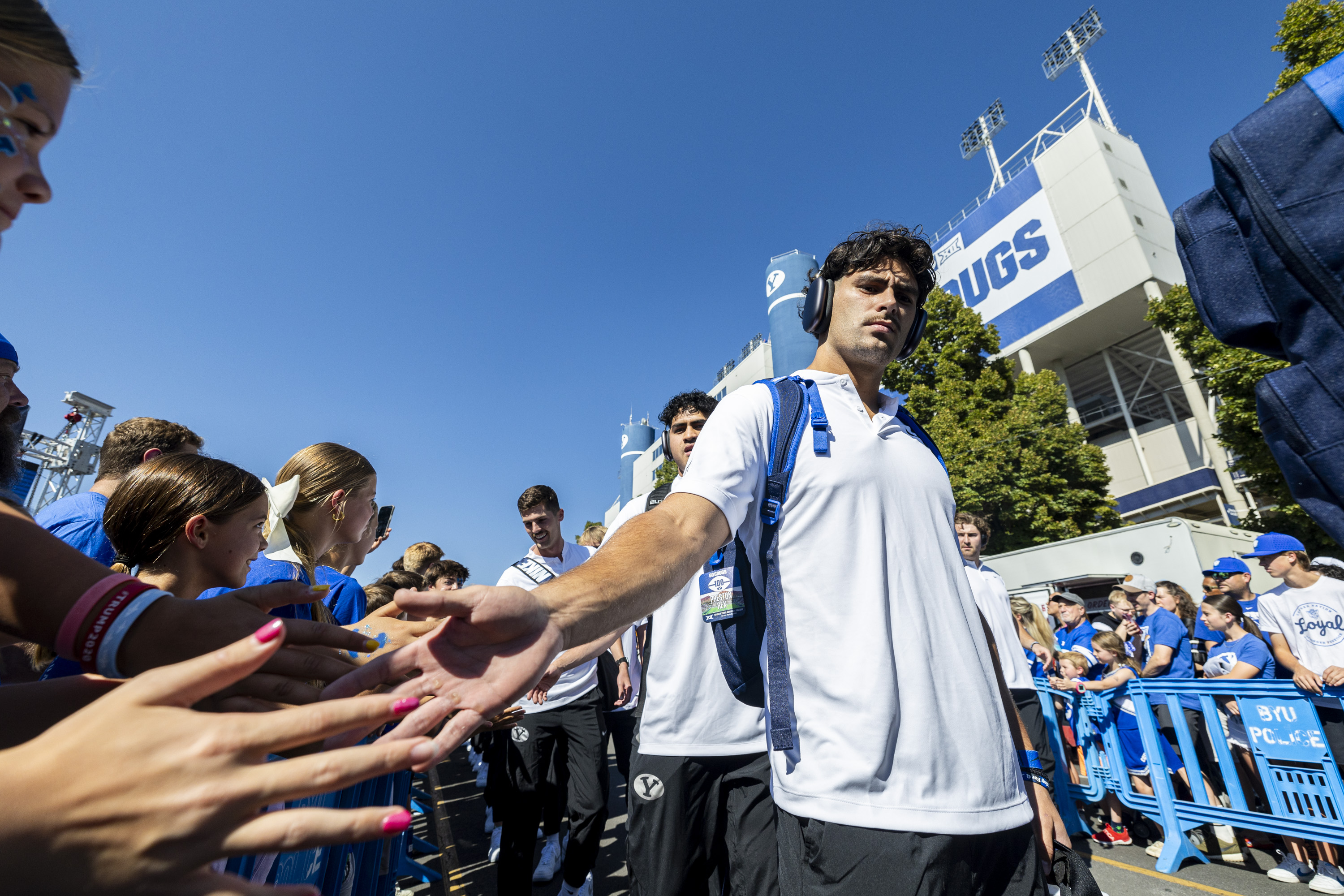 BYU safety Preston Rex (12) slaps hands with fans as he and his teammates make their way through Cougar Canyon before the home opener against Southern Illinois, Aug. 31, 2024. Rex has moved to running back for the 2025 season.