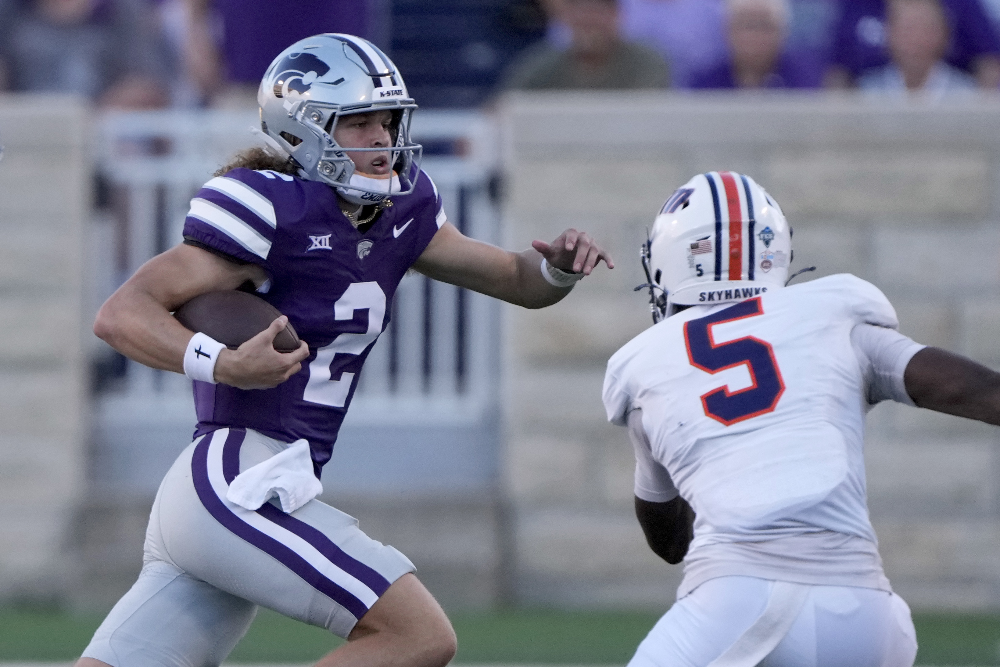 Kansas State quarterback Avery Johnson (2) runs past UT Martin linebacker Michael Pleas Jr. (2) during the first half of an NCAA college football game Saturday, Aug. 31, 2024, in Manhattan, Kan. 