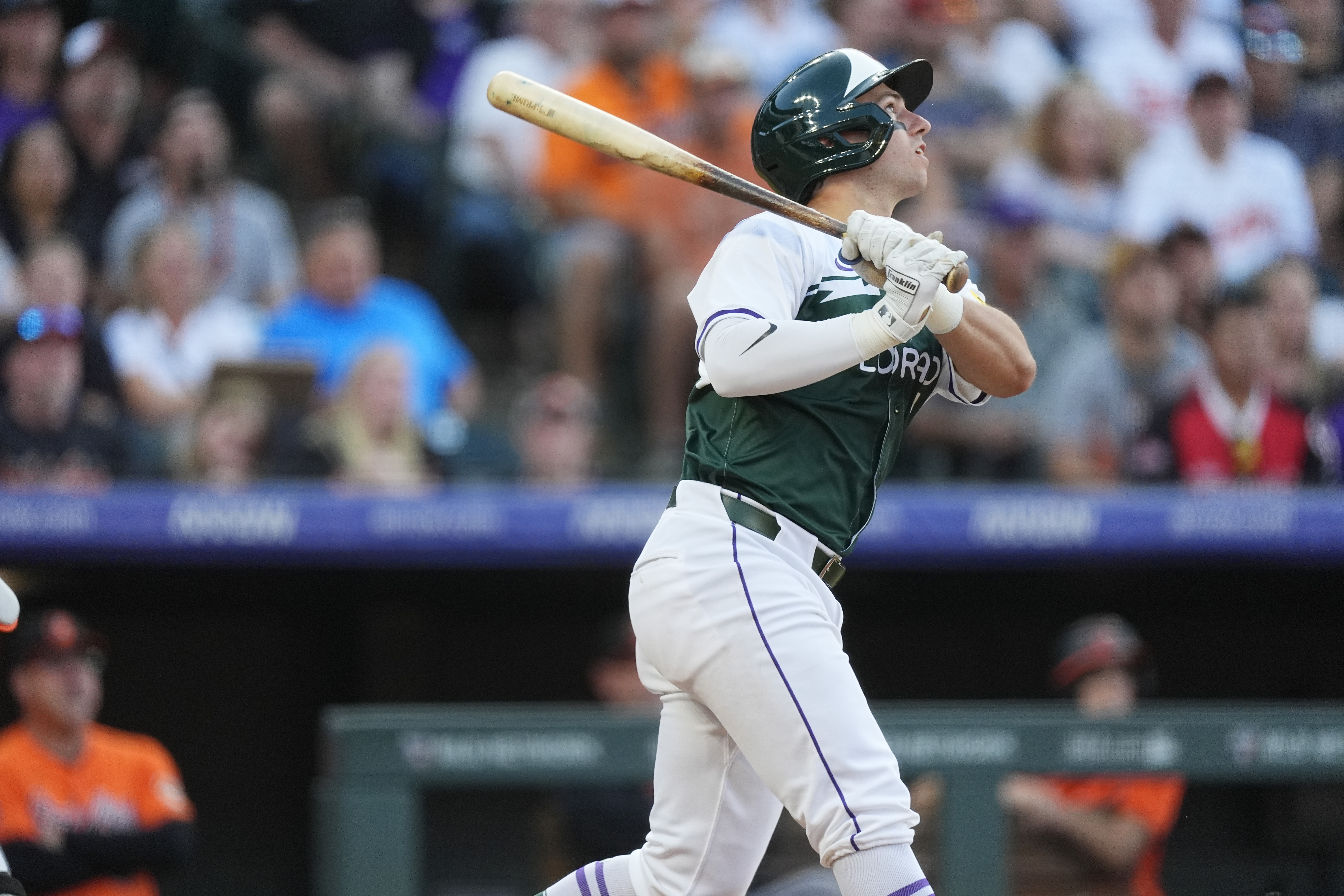 Colorado Rockies' Drew Romo follows the flight of his double to drive in two runs off Baltimore Orioles starting pitcher Dean Kremer in the second inning of a baseball game Saturday, Aug. 31, 2024, in Denver. 