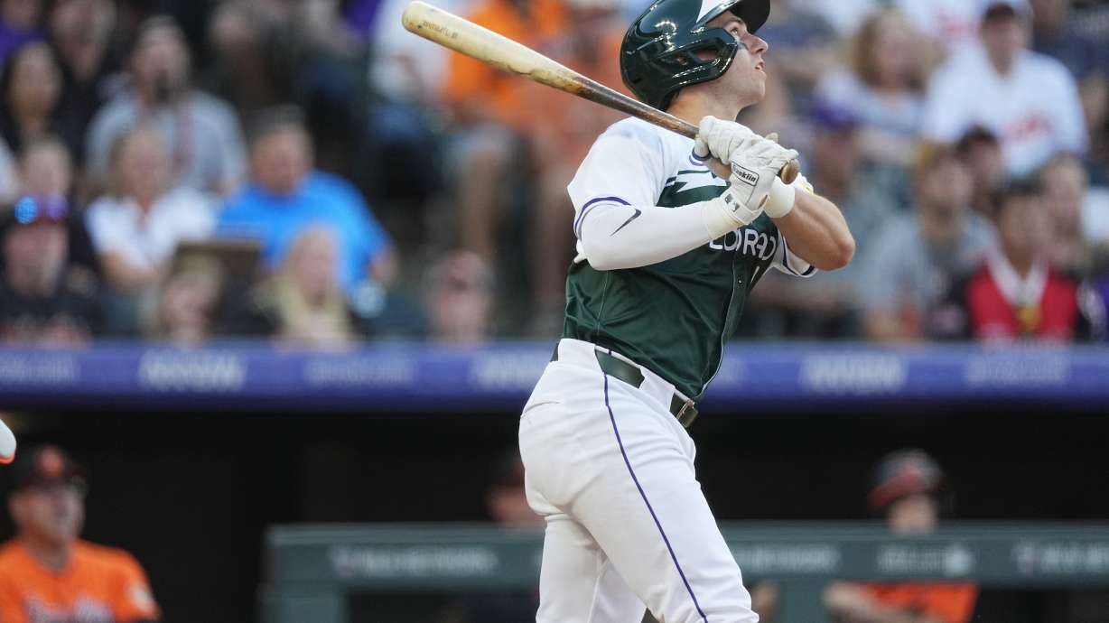 Colorado Rockies' Drew Romo follows the flight of his double to drive in two runs off Baltimore Orioles starting pitcher Dean Kremer in the second inning of a baseball game Saturday, Aug. 31, 2024, in Denver.