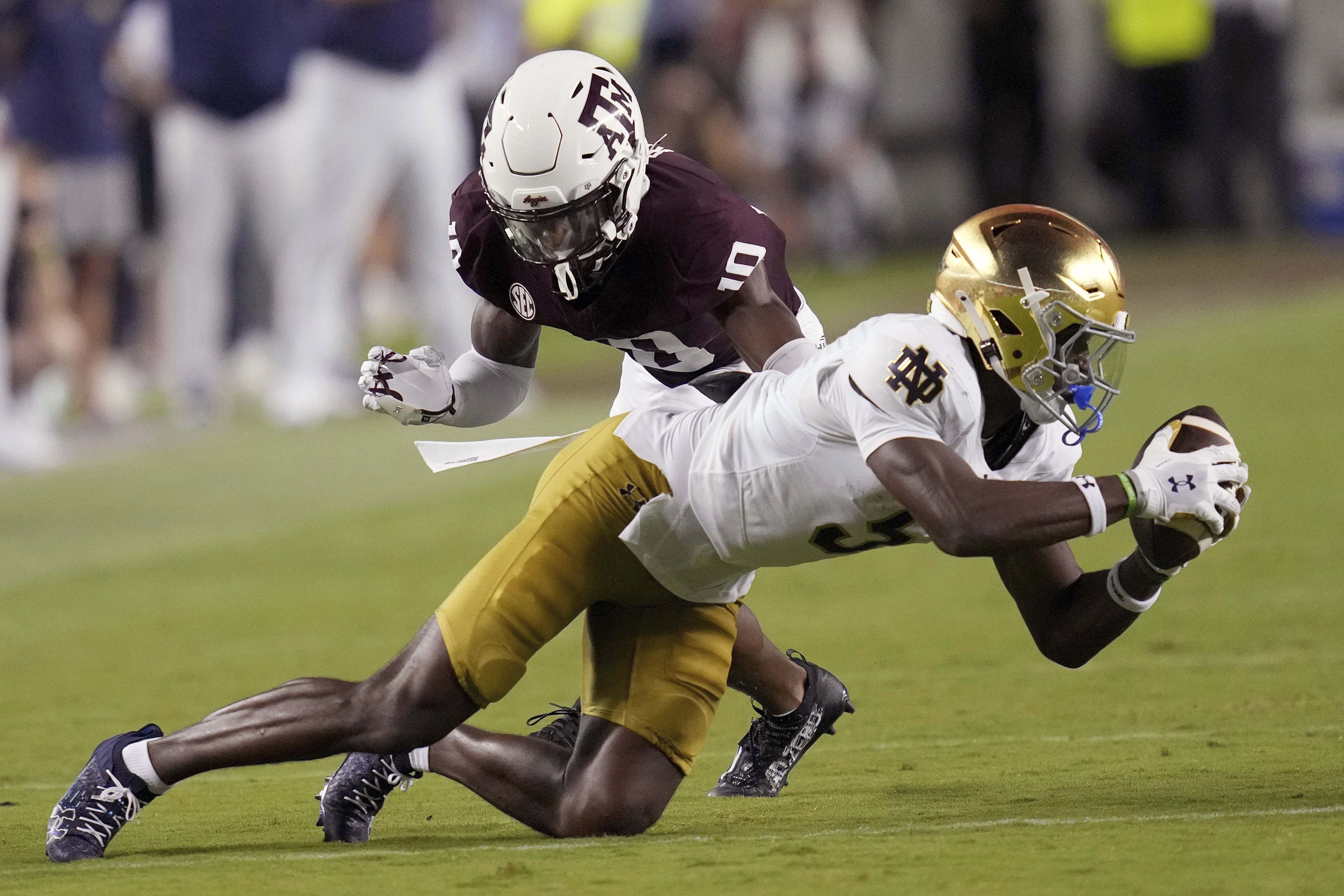 Notre Dame wide receiver Beaux Collins (5) catches a pass against Texas A&M defensive back Dezz Ricks (10) for a first down during the fourth quarter of an NCAA college football game Saturday, Aug. 31, 2024, in College Station, Texas.