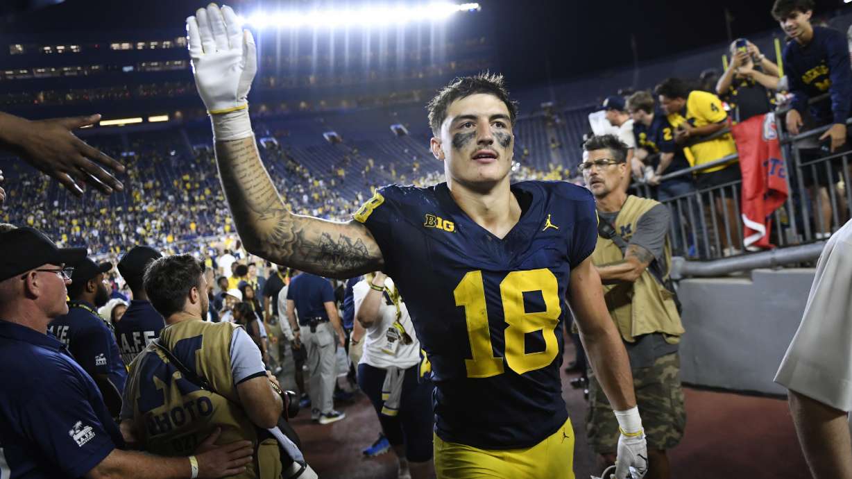 Michigan's Colston Loveland celebrates with fans following an NCAA college football game against Fresno State, Saturday, Aug. 31, 2024, in Ann Arbor, Mich.