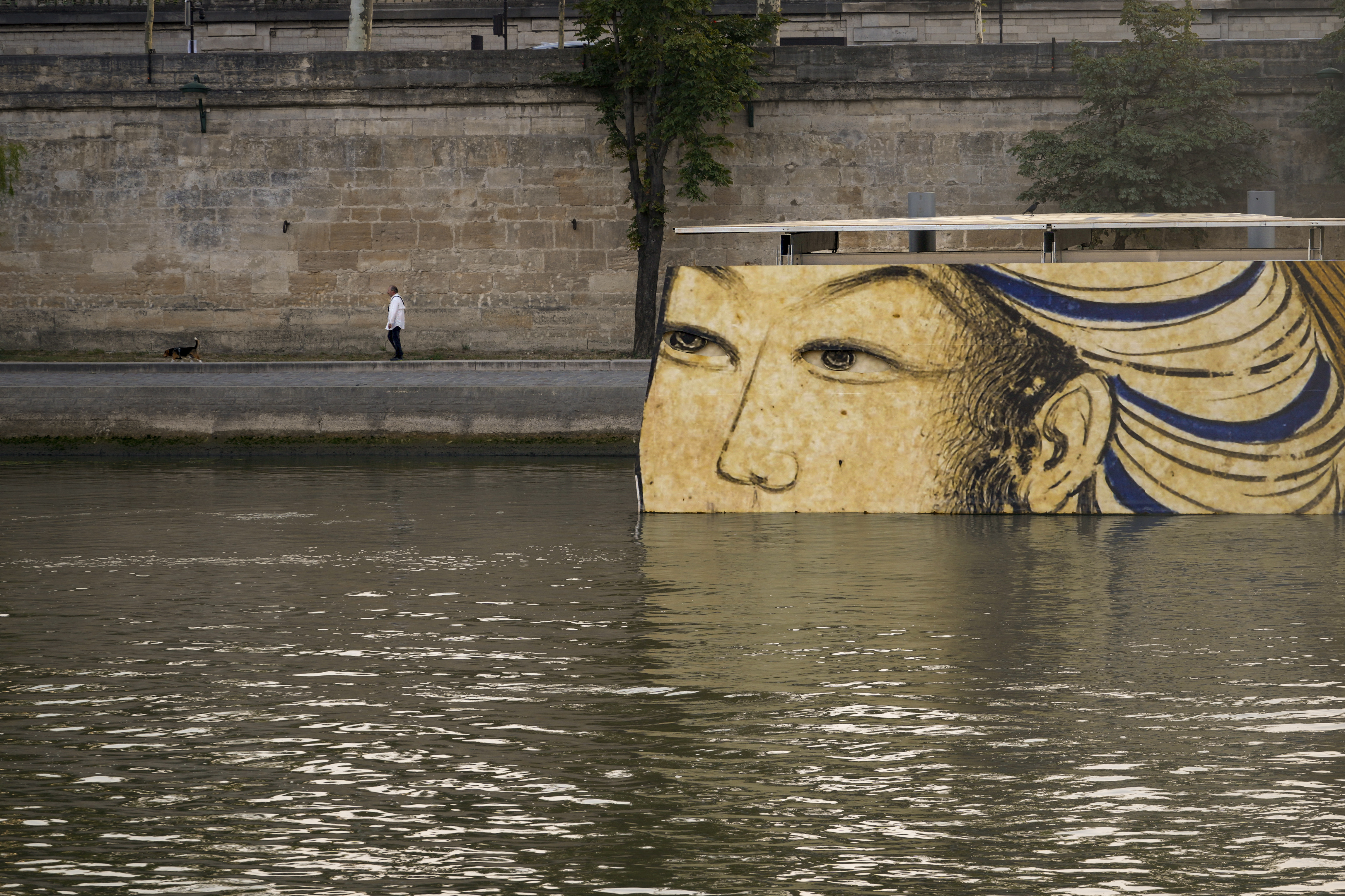 FILE - Reproductions of artworks decorate the banks of the River Seine at the 2024 Summer Olympics, Tuesday, July 30, 2024, in Paris, France. Concerns over water quality in the Seine River resurfaced at the Paralympic Games on Thursday when organizers changed the schedule for para triathlon races. 