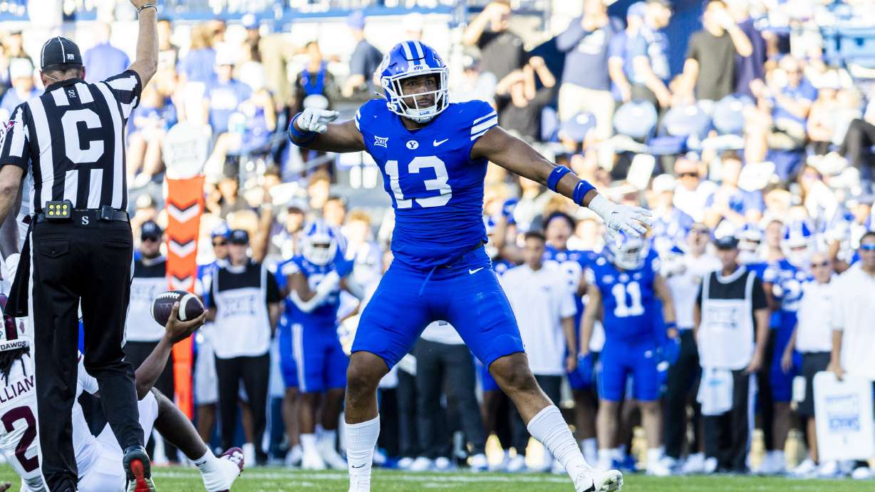 Brigham Young defensive end Isaiah Bagnah (13) celebrates after a play during BYU’s home opener against Southern Illinois University held at LaVell Edwards Stadium in Provo on Saturday, Aug. 31, 2024.