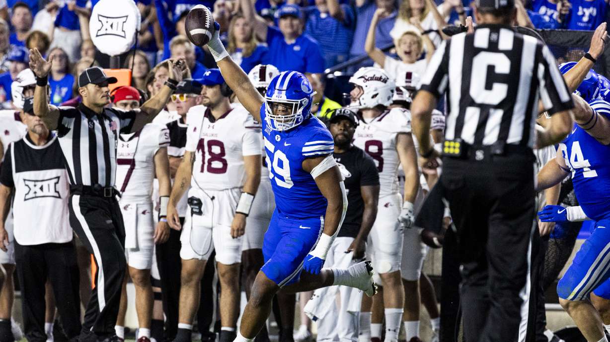 Brigham Young defensive end Logan Lutui (59) celebrates after recovering a fumble from Southern Illinois University during BYU’s home opener held at LaVell Edwards Stadium in Provo on Saturday, Aug. 31, 2024.