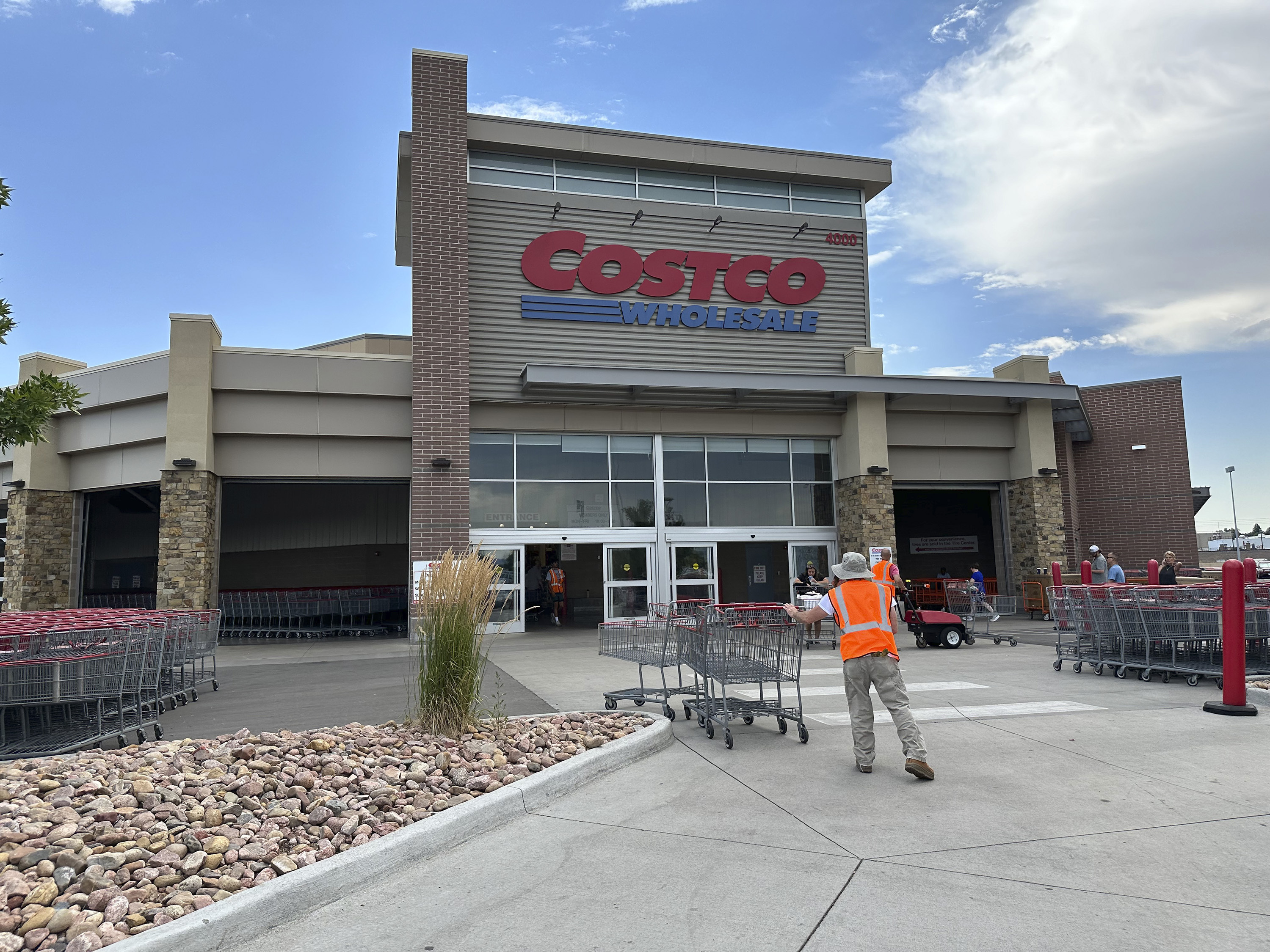 A cart wrangler works in front of a Costco warehouse on July 16, 2024, in Sheridan, Colo. 