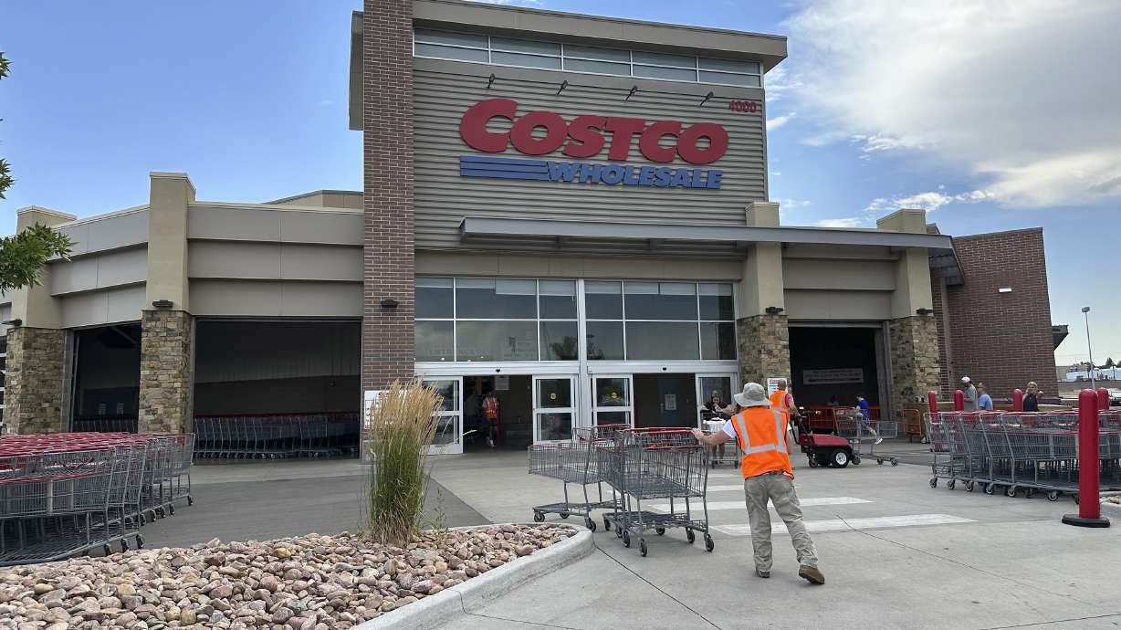 A cart wrangler works in front of a Costco warehouse on July 16, 2024, in Sheridan, Colo.