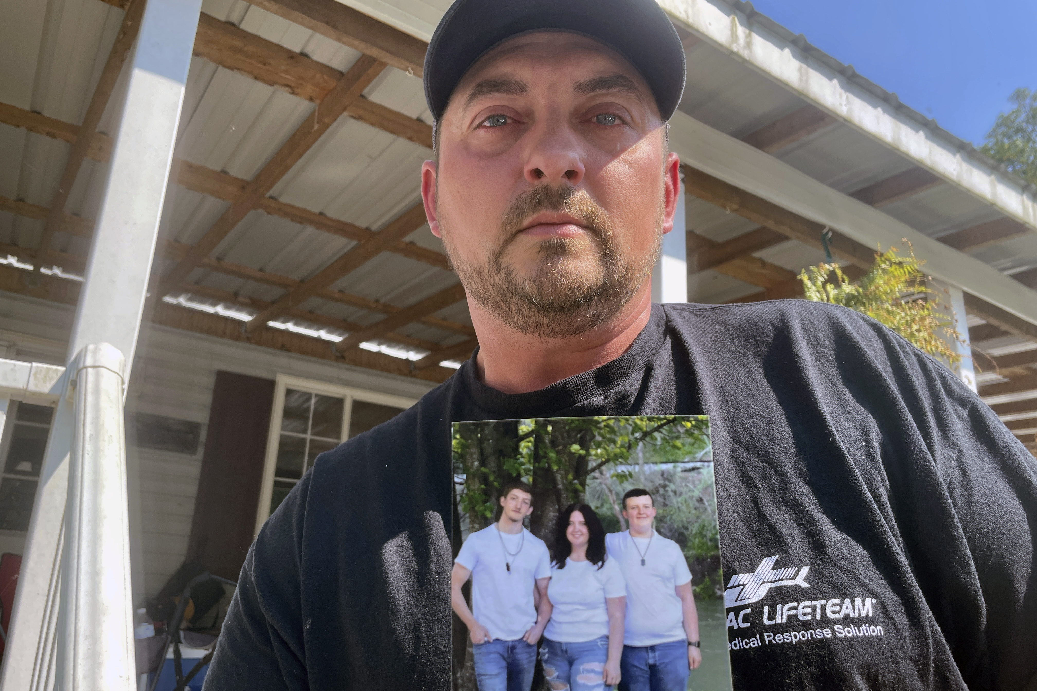 Ryan Craddock holds a photo of his three children, from left, Shawn Craddock, 18; Kendall Craddock, 17, and Cohen Craddock, 13, at his home in Hewett, W. Va., on Thursday, Aug. 29, 2024. Cohen died Saturday, Aug. 24, 2024, a day after he received a head injury while making a tackle during his middle school's football practice.