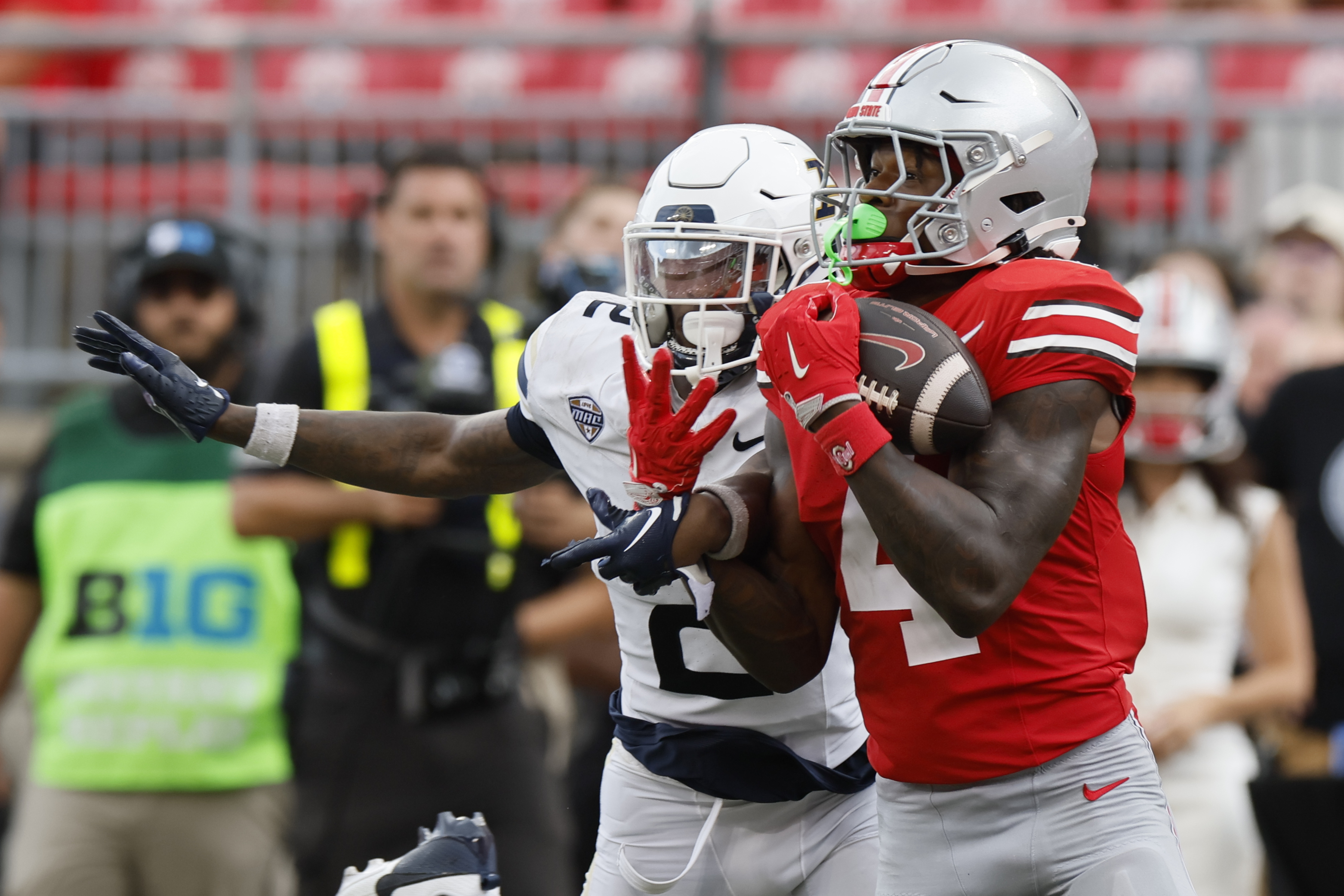 Ohio State receiver Jeremiah Smith, right, catches a pass in front of Akron defensive back Daymon David, left, during the second half of an NCAA college football game Saturday, Aug. 31, 2024, in Columbus, Ohio. 