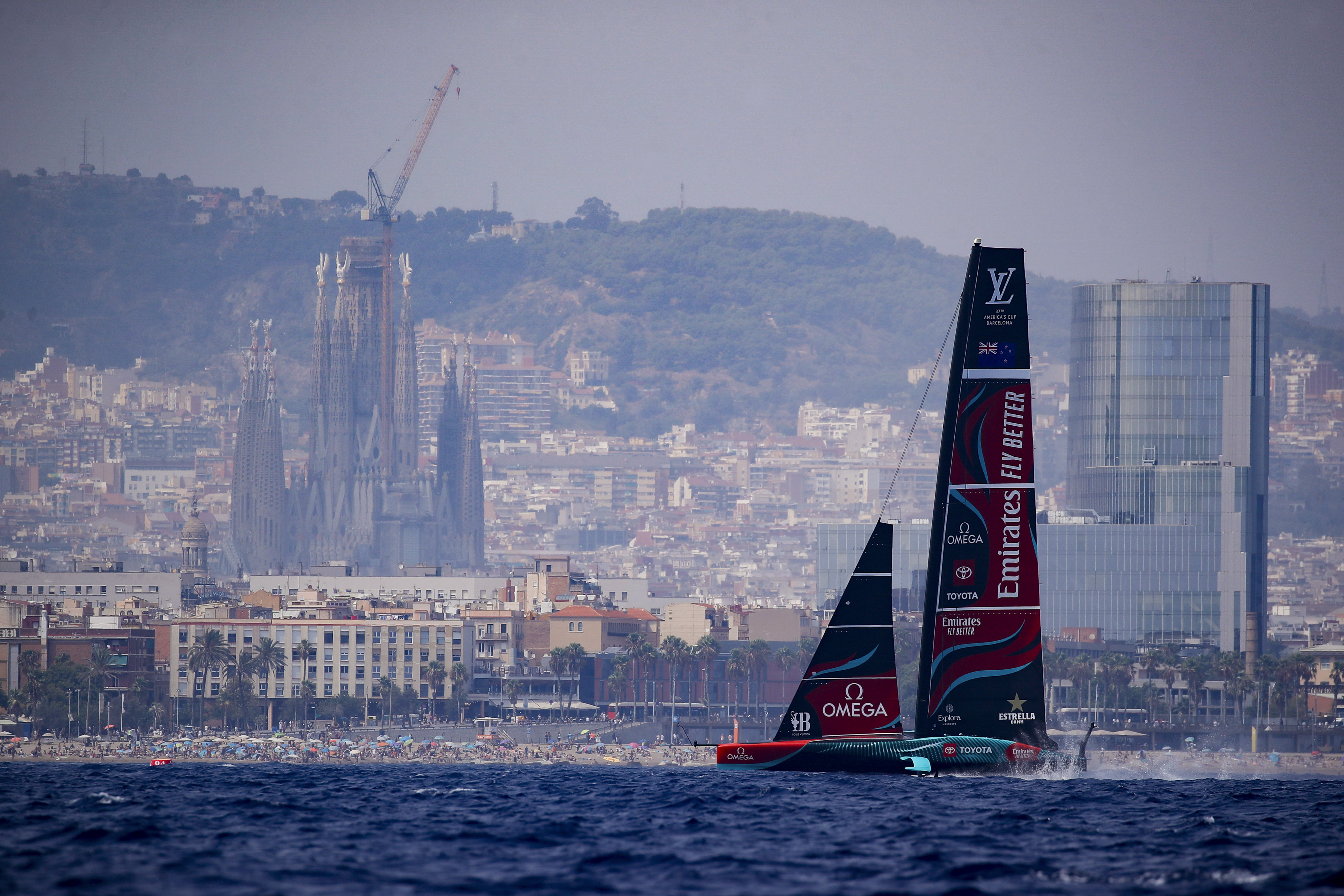 Backdrooped by the Sagrada Familia church, Emirates Team New Zealand's AC75 boat sails during America's Cup Preliminary Regatta ahead of the 37th America's Cup sailing race at the Barcelona's coast, Spain, Thursday, Aug. 22, 2024. The world's oldest international sports trophy, best yachtsmen and cutting-edge design and technology will come together in Barcelona when the 37th edition of the America's Cup starts on Thursday. 