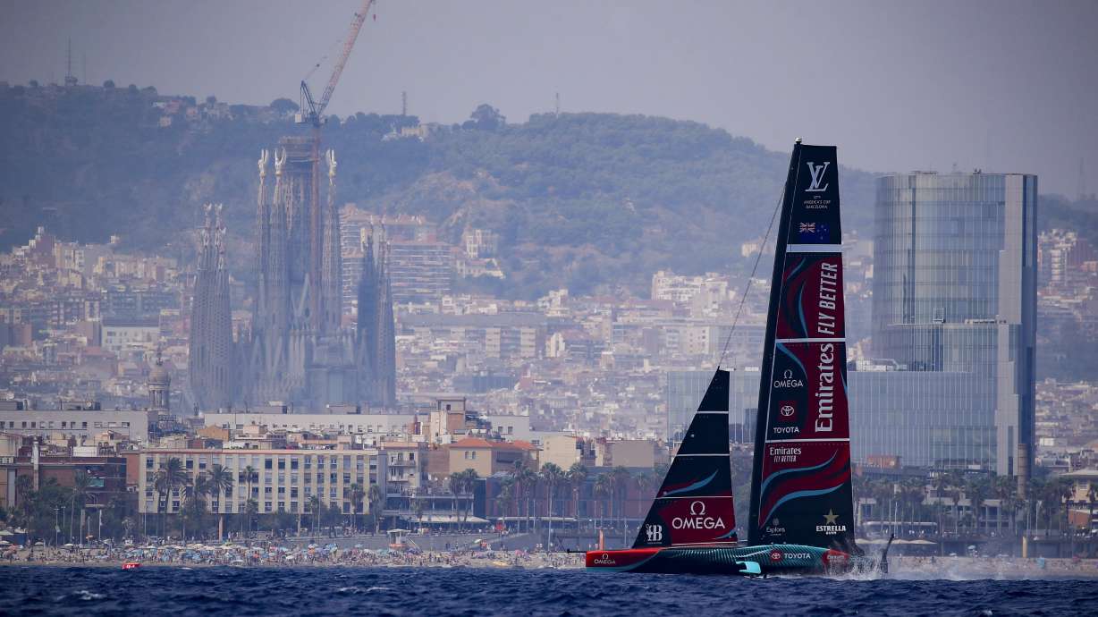 Backdrooped by the Sagrada Familia church, Emirates Team New Zealand's AC75 boat sails during America's Cup Preliminary Regatta ahead of the 37th America's Cup sailing race at the Barcelona's coast, Spain, Thursday, Aug. 22, 2024. The world's oldest international sports trophy, best yachtsmen and cutting-edge design and technology will come together in Barcelona when the 37th edition of the America's Cup starts on Thursday.