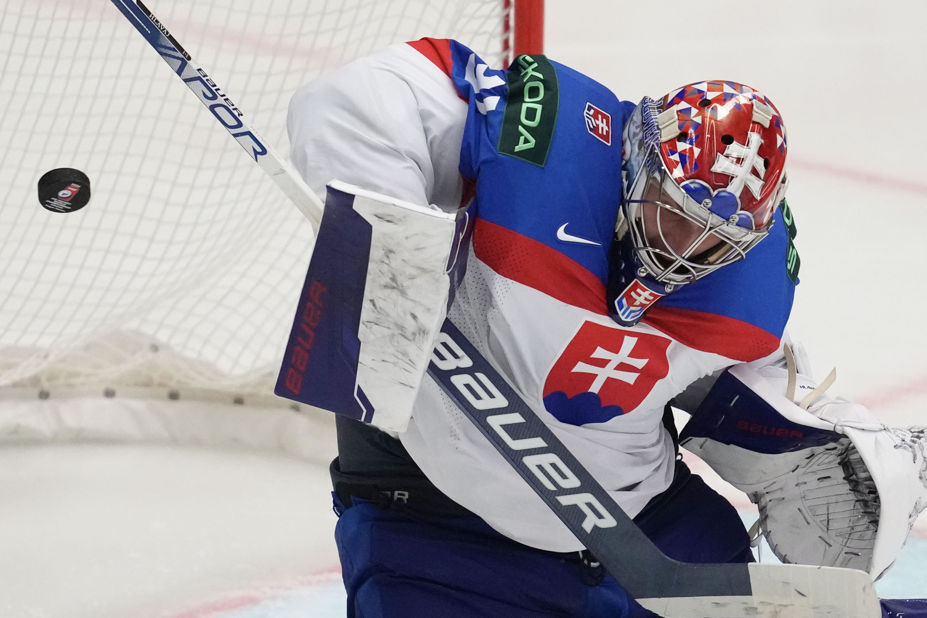 FILE - Slovakia's goalkeeper Samuel Hlavaj makes a save during the preliminary round match between France and Slovakia at the Ice Hockey World Championships in Ostrava, Czech Republic, May 18, 2024. 