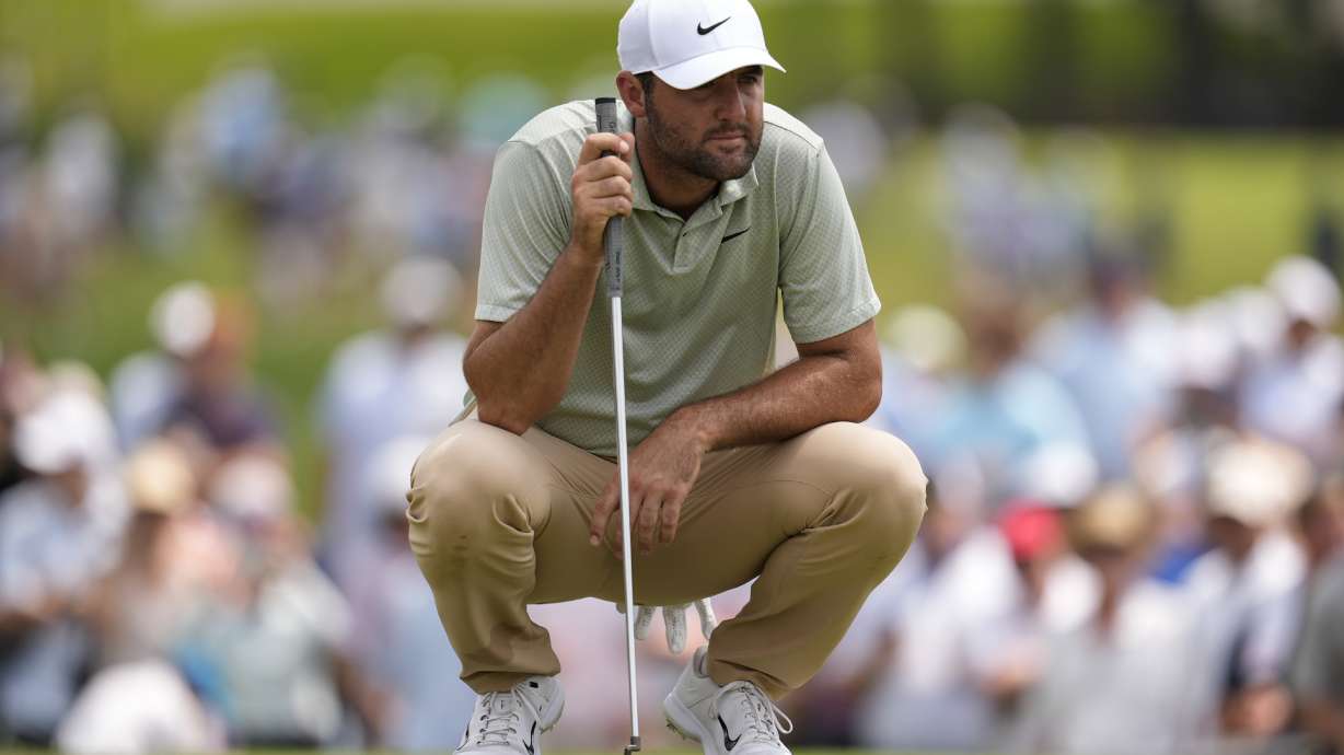 Scottie Scheffler lines up a putt on the third green during the final round of the Tour Championship golf tournament, Sunday, Sept. 1, 2024, in Atlanta.