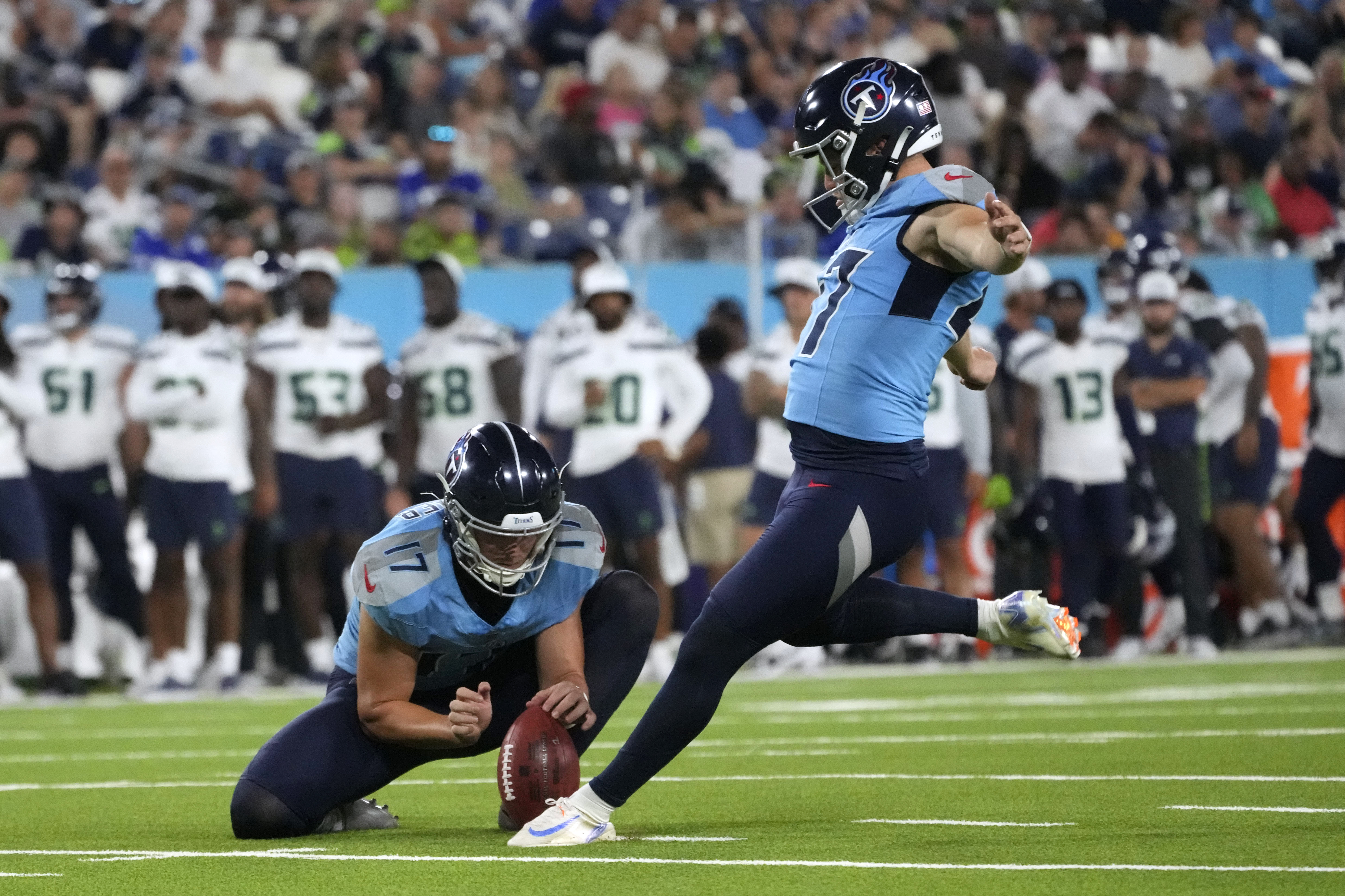 Tennessee Titans kicker Brayden Narveson, right, kicks a 21-yard field goal during the second half of an NFL preseason football game against the Seattle Seahawks, Saturday, Aug. 17, 2024, in Nashville, Tenn. 