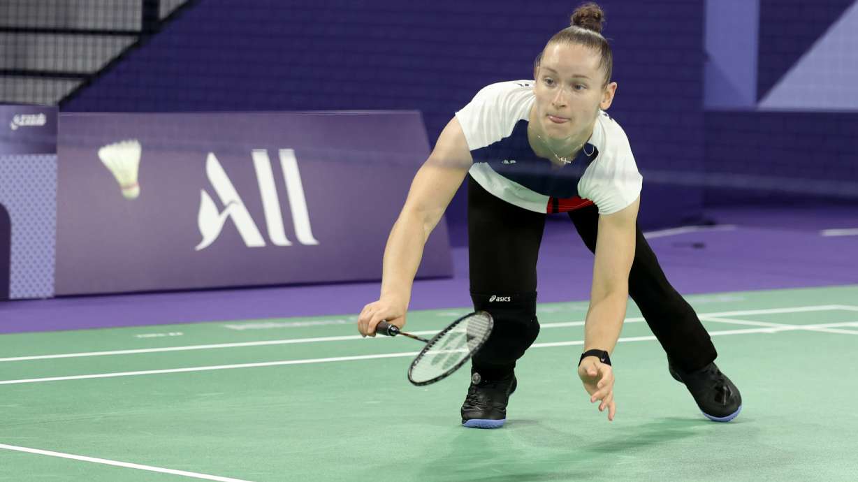 Oksana Kozyna, from Ukraine, reaches to hit the shuttlecock during the semifinal match of the Para Badminton SL3 classification against Qonitah Ikhtiar Syakuroh from Indonesia during the Paralympic Games in Paris on Sunday, Sept. 1, 2024. Syakuroh won the game in straight sets.