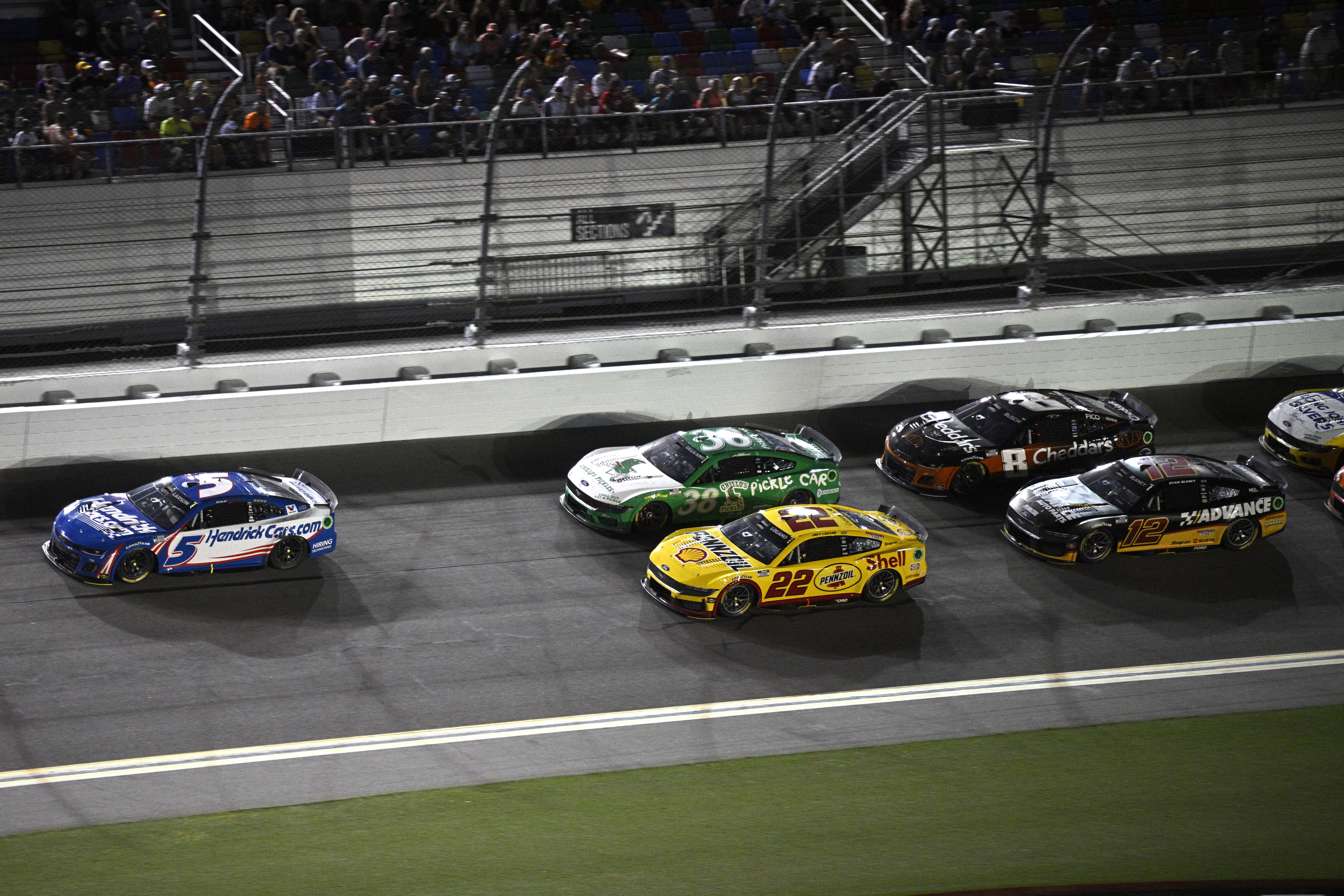 Kyle Larson (5) leads Todd Gilliland (38), Joey Logano (22), Kyle Busch (8) and Ryan Blaney (12) through the front stretch during a NASCAR Cup Series auto race at Daytona International Speedway, Saturday, Aug. 24, 2024, in Daytona Beach, Fla.
