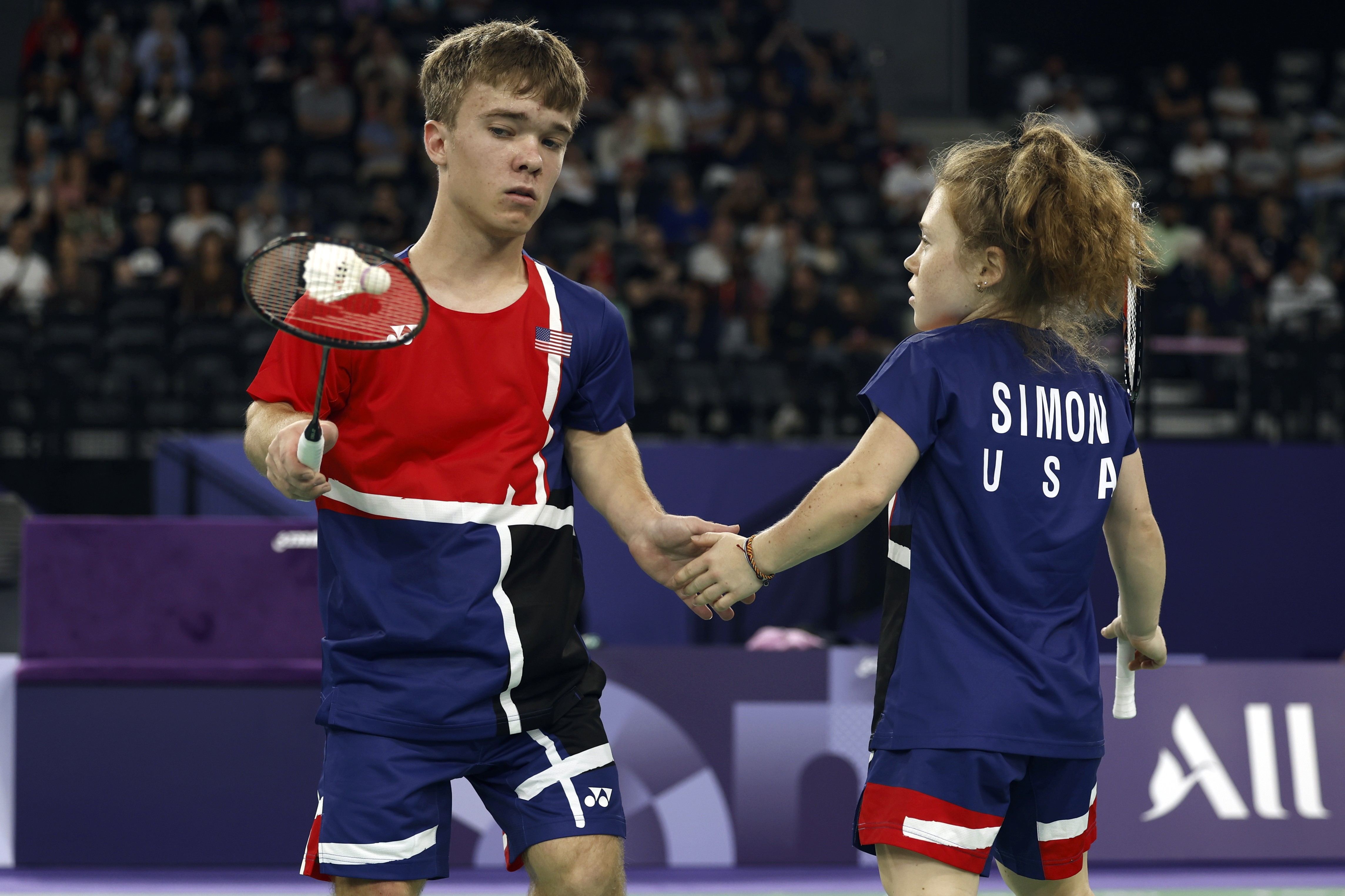 Miles Krajewski, left, and Jayci Simon, from the U.S., high-five during the gold medal match against Naili Lin and Fengmei Li, from China, during the Paralympic Games in Paris on Monday, Sept. 2, 2024. China won the match in straight sets.