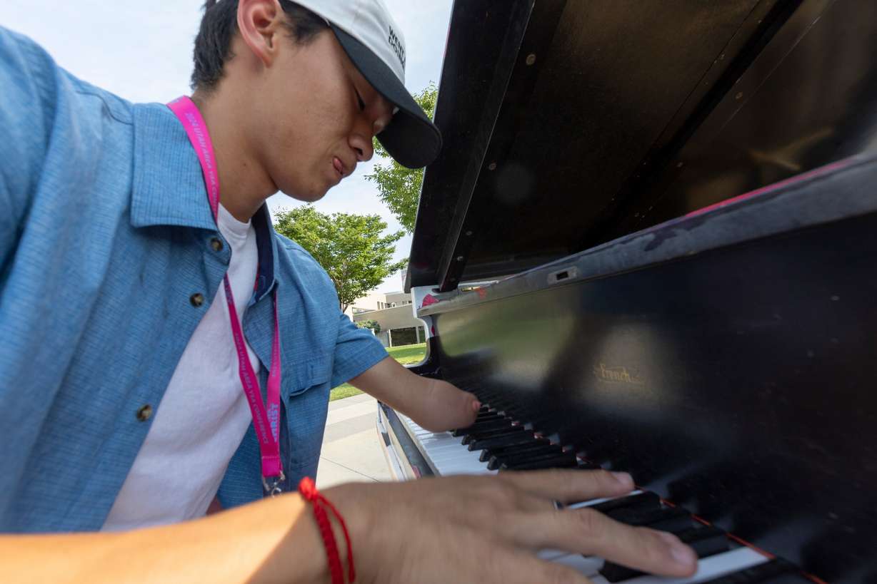Seth Dobson, from Highland, plays on one of the pianos in front of Maurice Abravanel Hall in Salt Lake City on Aug. 2. Dobson, who was born without a left hand, has been playing piano for 12 years and has also been playing as an organist for two years.