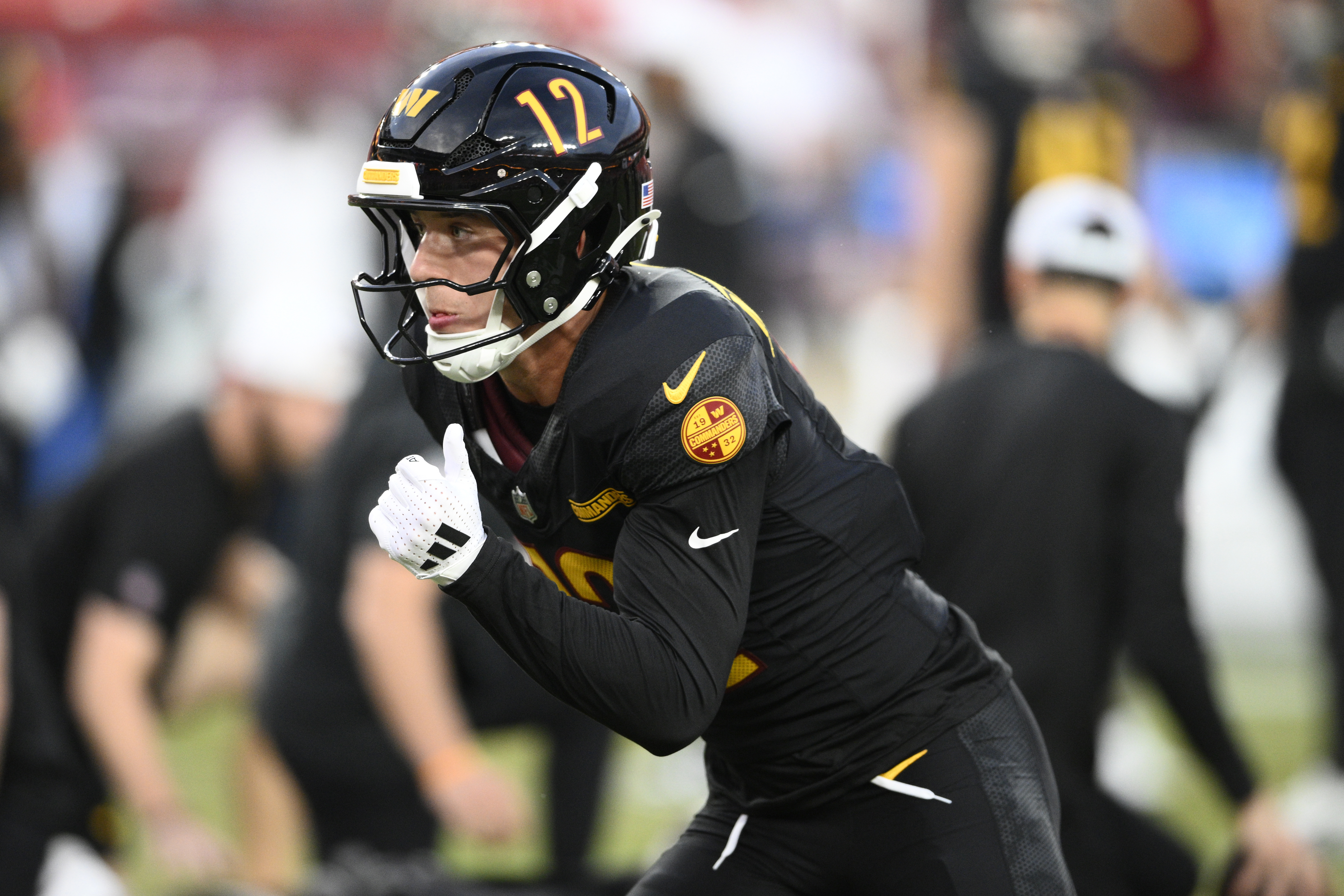 FILE - Washington Commanders wide receiver Luke McCaffrey works out before an NFL preseason football game against the New England Patriots, on Aug. 25, 2024, in Landover, Md. Luke McCaffrey this weekend will become the latest member of his family to play in the NFL.