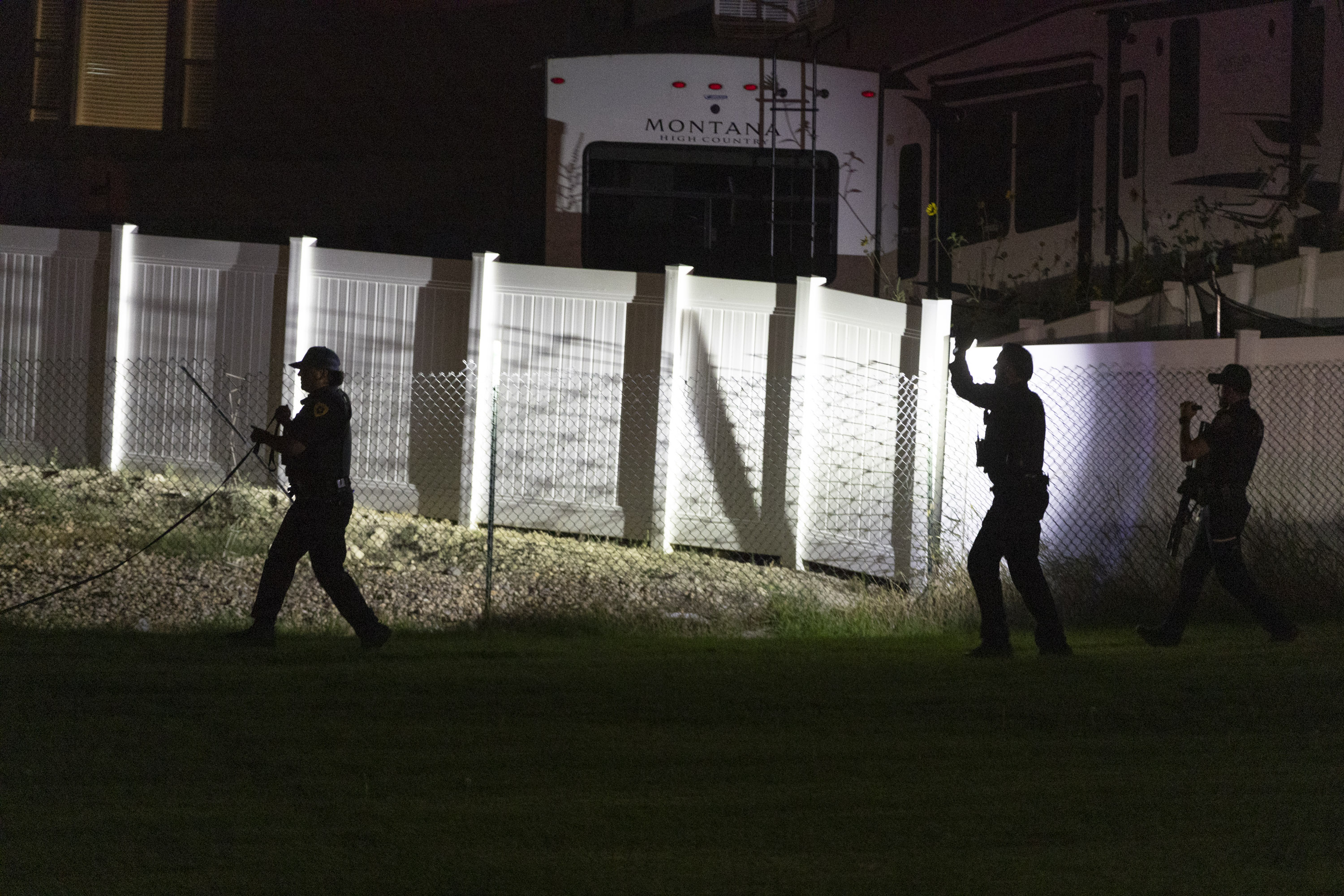 Police look for a suspect and evidence after a shooting at Oquirrh Park in Kearns on Sunday.