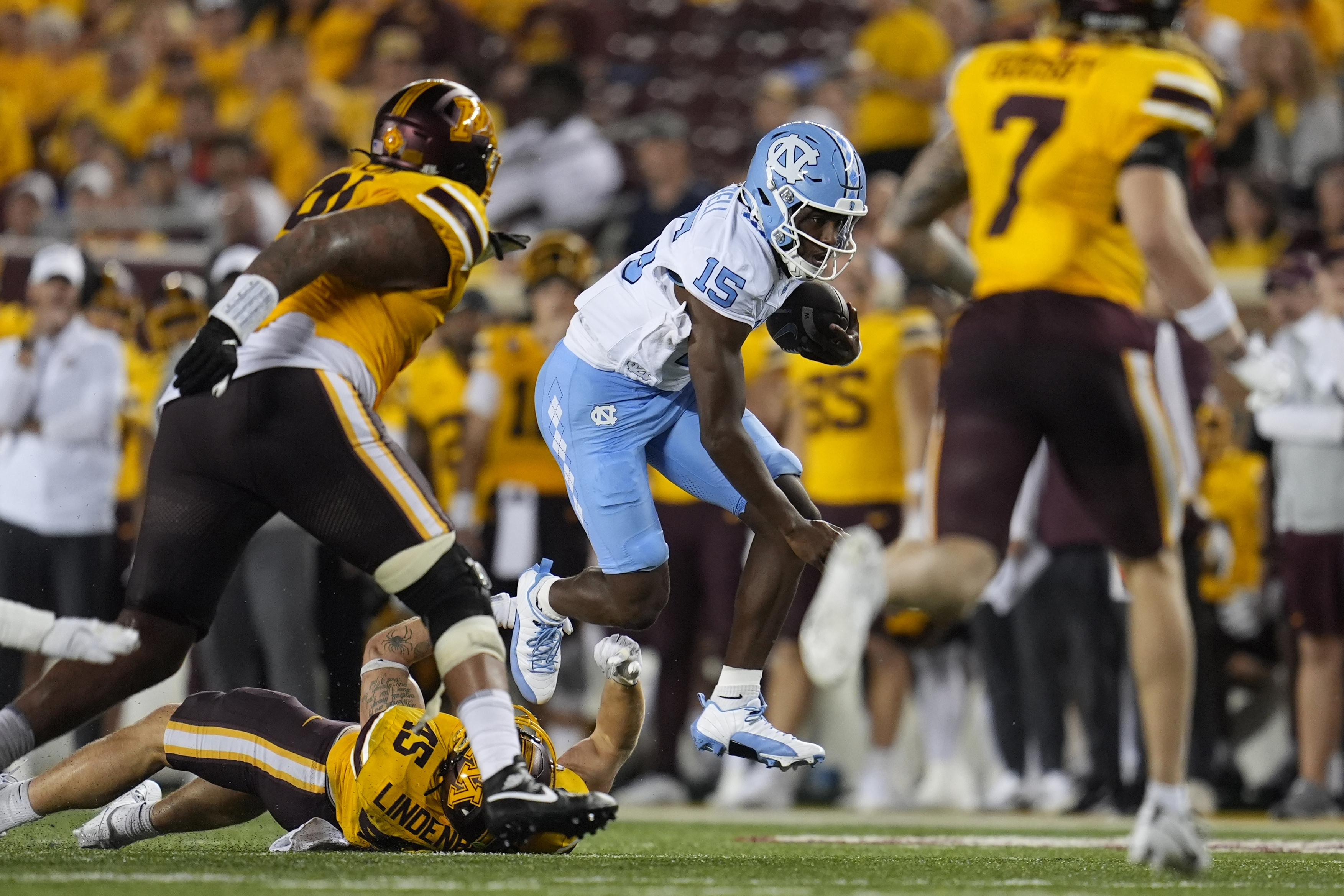 North Carolina quarterback Conner Harrell (15) runs with the football during the second half of an NCAA college football game against Minnesota, Thursday, Aug. 29, 2024, in Minneapolis. 