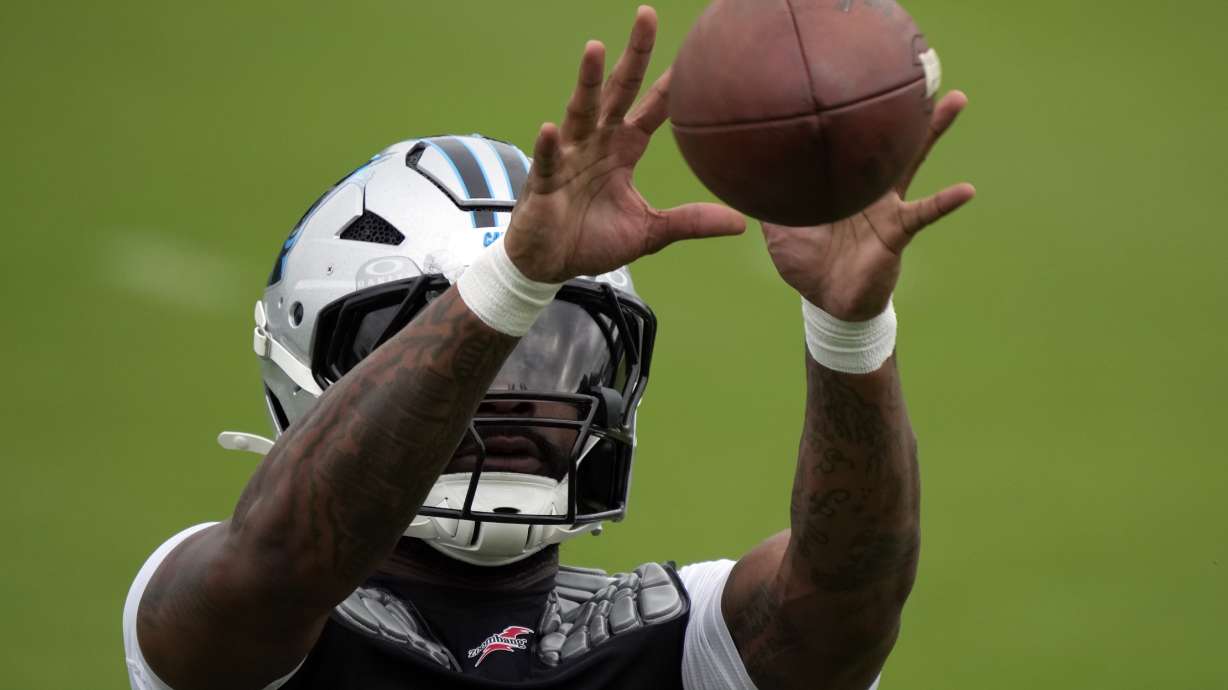 Carolina Panthers running back Miles Sanders reacts for a catch during the NFL football team's training camp in Charlotte, N.C., Sunday, Aug. 4, 2024.