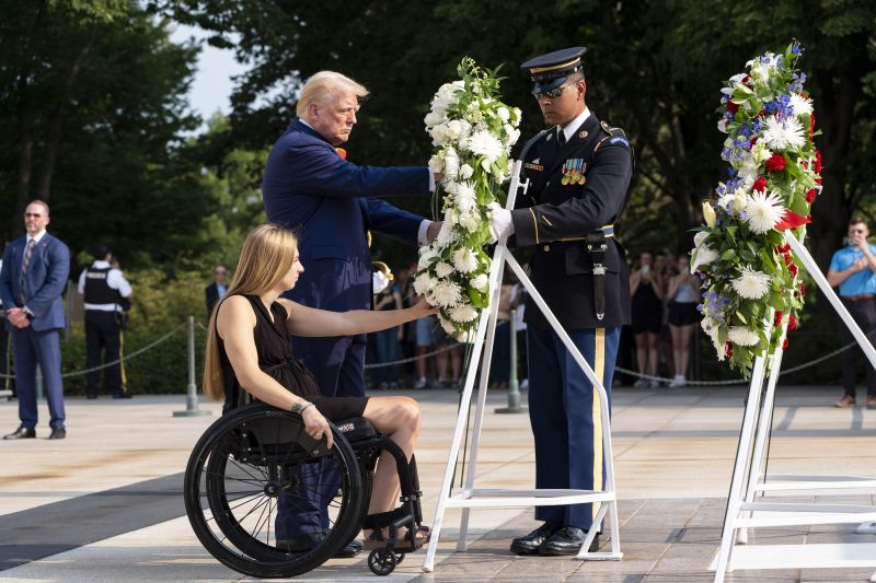 Former U.S. Marine Corps Cpl. Kelsee Lainhart, left, and Republican presidential nominee former President Donald Trump place a wreath at the Tomb of the Unknown Solider in honor of the 13 service members killed at Abbey Gate, at Arlington National Cemetery, Aug. 26 in Arlington, Va.