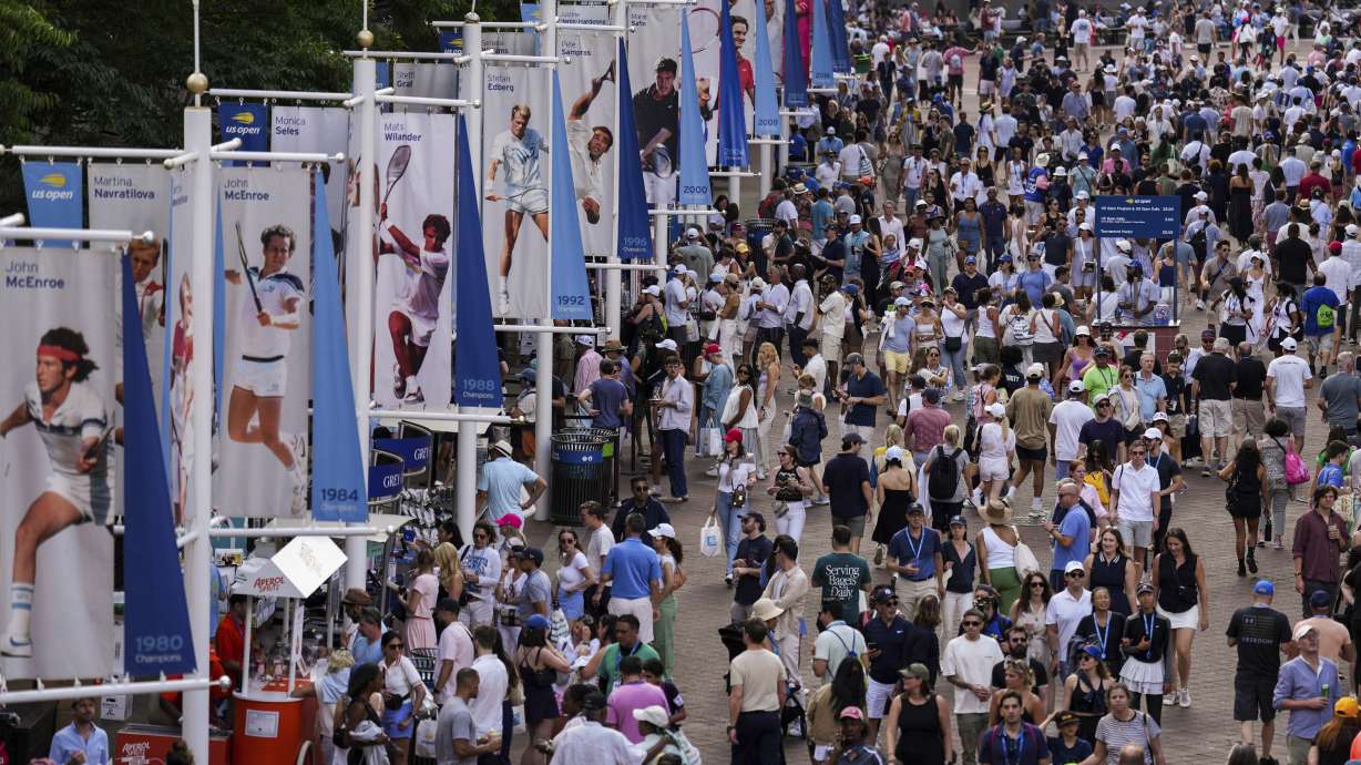 People walk through the USTA Billie Jean King National Tennis Center during the U.S. Open tennis championships, Monday, Sept. 2, 2024, in New York.