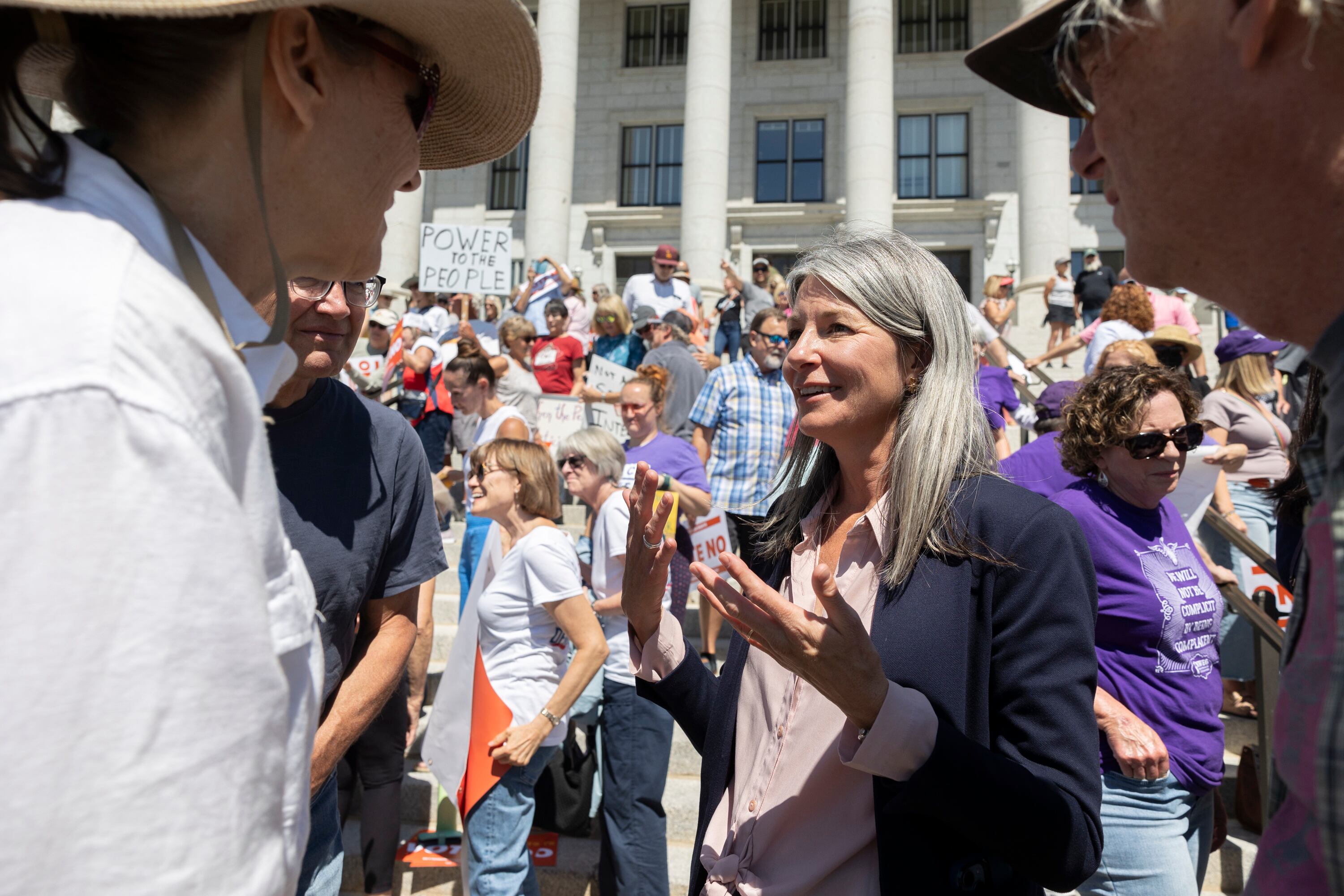 Katie Wright, executive director of Better Boundaries, talks with supporters at the state Capitol building in Salt Lake City on Aug. 26. Utah voters will have a chance to weigh a proposed amendment to the state constitution.