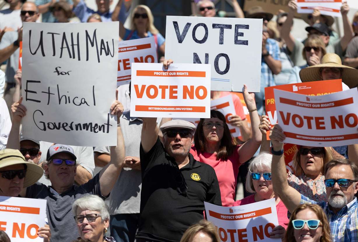 Supporters with signs stand on the state Capitol building steps during a rally by Better Boundaries in Salt Lake City on Aug. 26.