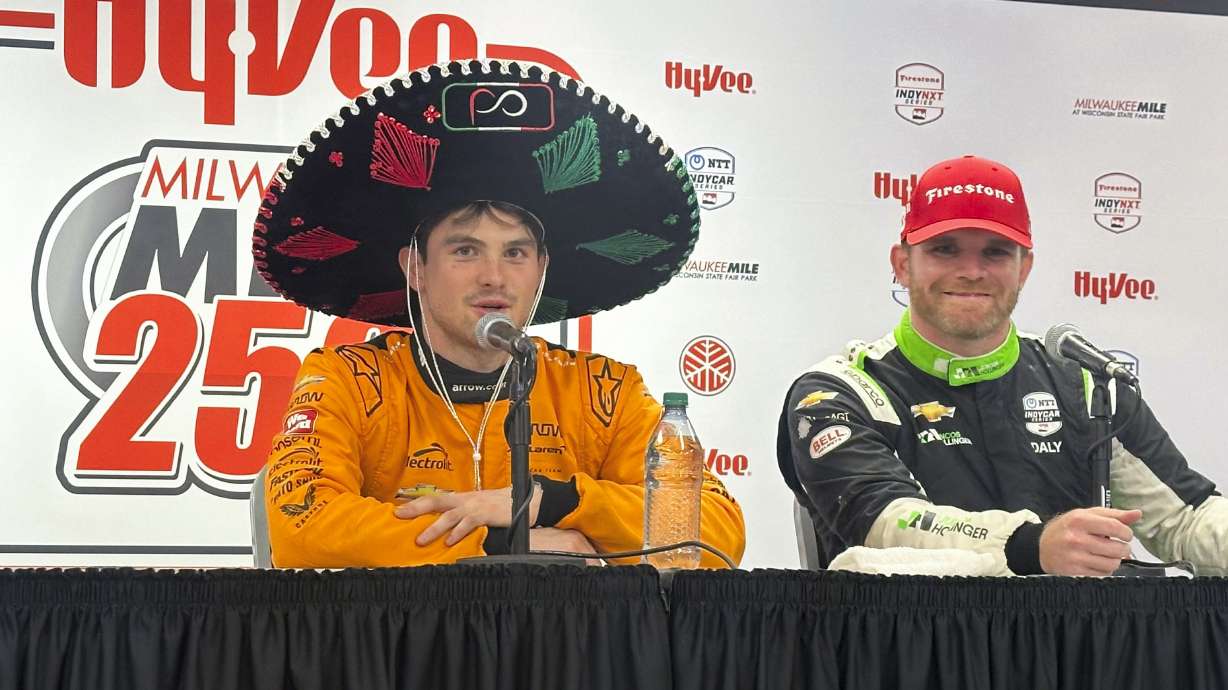 Pato O’Ward, of Mexico, left, wears a sombrero at the post-race news conference after winning the IndyCar auto race at the Milwaukee Mile in West Allis, Wis., Saturday, Aug. 31, 2024.