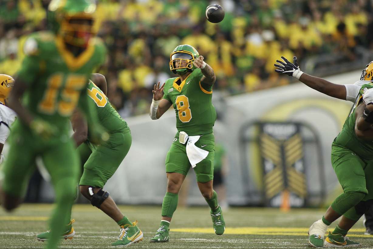 Oregon quarterback Dillon Gabriel, center, throws a pass during the second half of an NCAA college football game against Idaho, Saturday, Aug. 31, 2024, in Eugene, Ore.