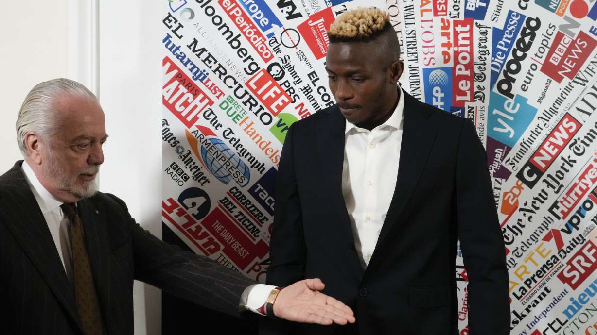FILE - SS Napoli striker Victor Osimhen, right, arrives with team President Aurelio De Laurentiis, at the Foreign Press club to receive the "Best Foreign Athlete of the Year" award, in Rome, Monday, March 6, 2023.