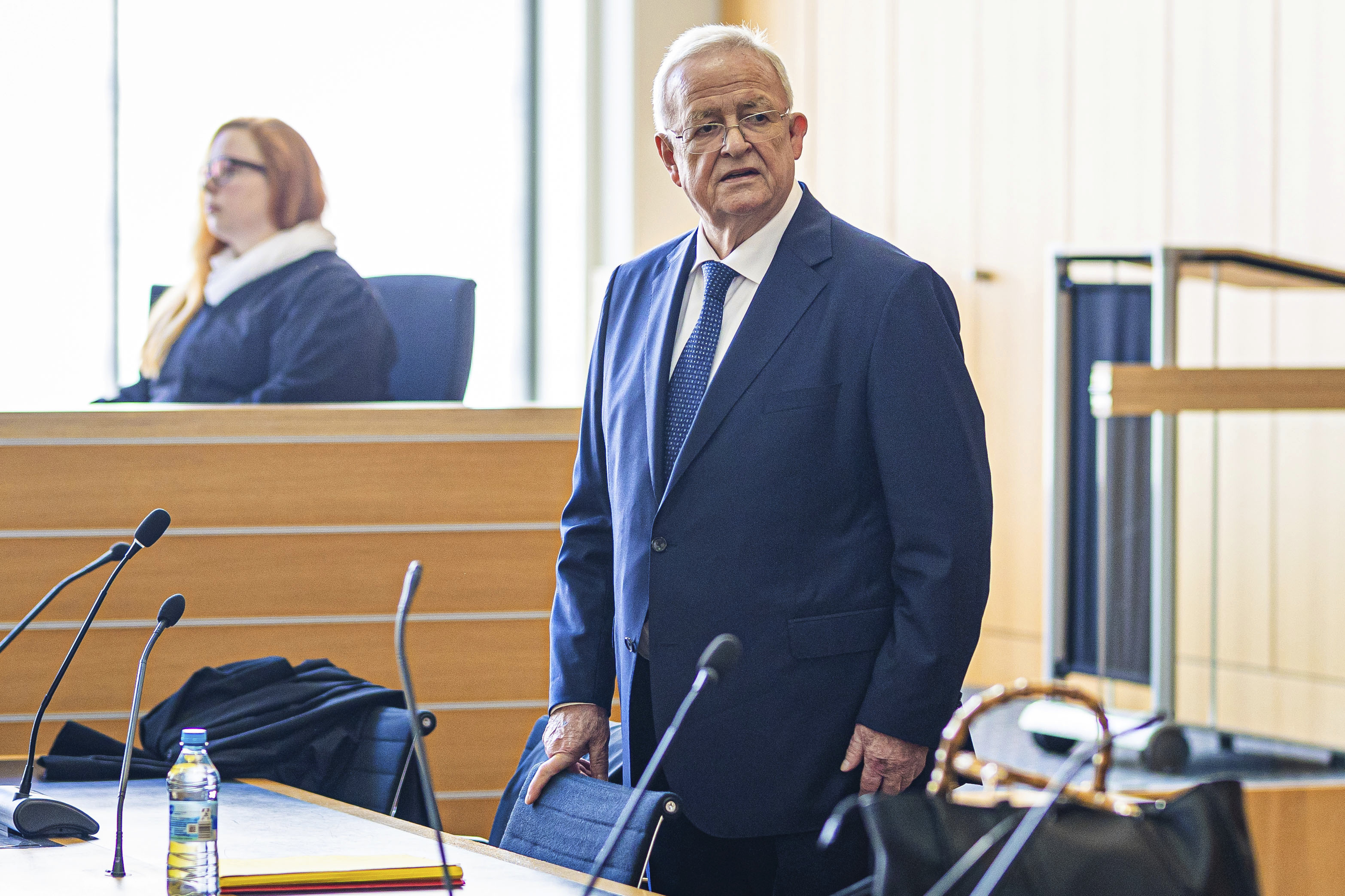 Former Volkswagen Group CEO Martin Winterkorn stands in a hall of the Braunschweig Regional Court in Brunswick, Germany, Tuesday. Winterkorn has gone on trial on charges of fraud and market manipulation.