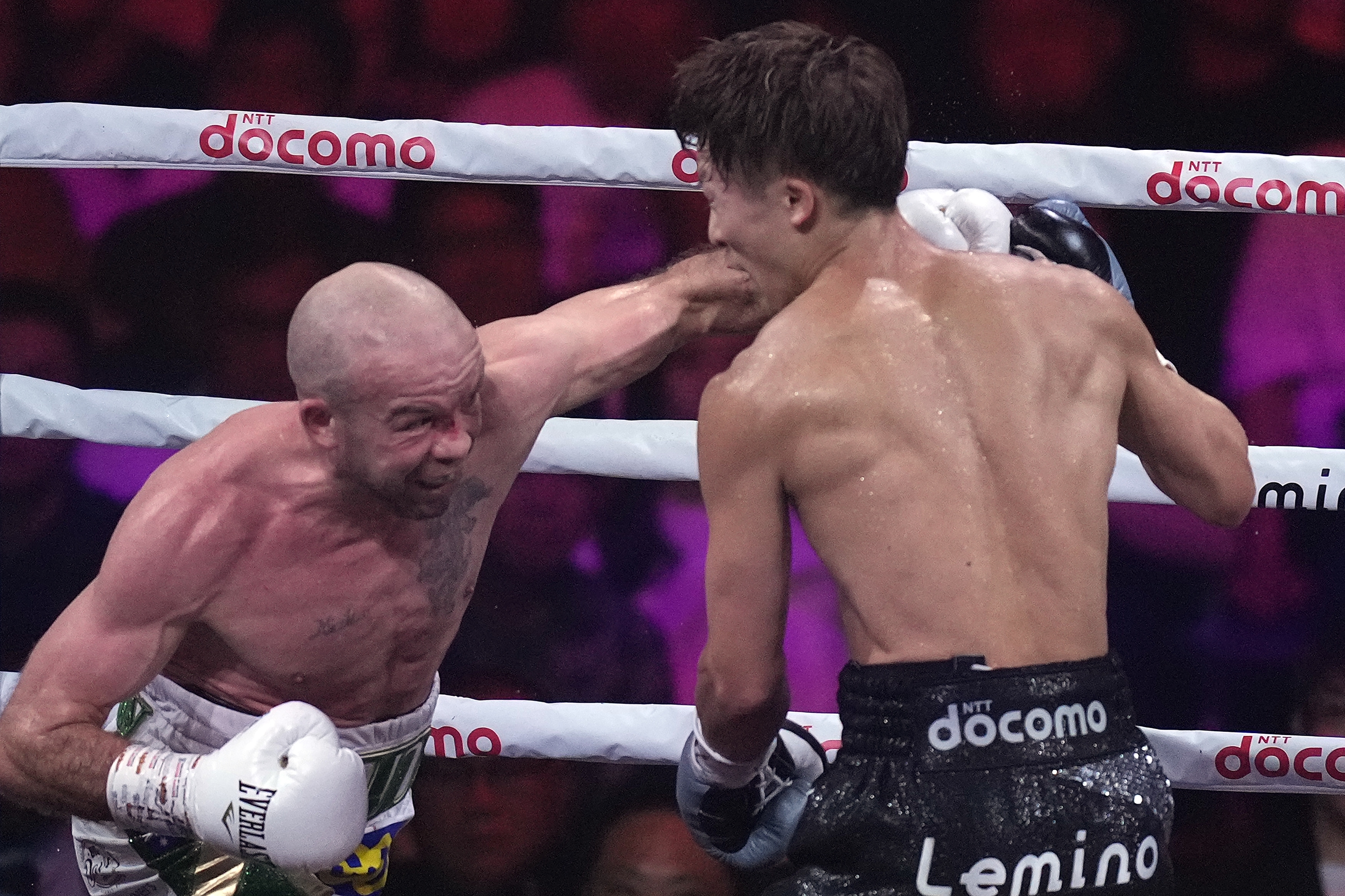 Japanese champion Naoya Inoue, right, and Irish challenger TJ Doheny, left, fight during the first round of a boxing match for the unified WBA, WBC, IBF and WBO super bantamweight world titles in Tokyo, Tuesday, Sept. 3, 2024.
