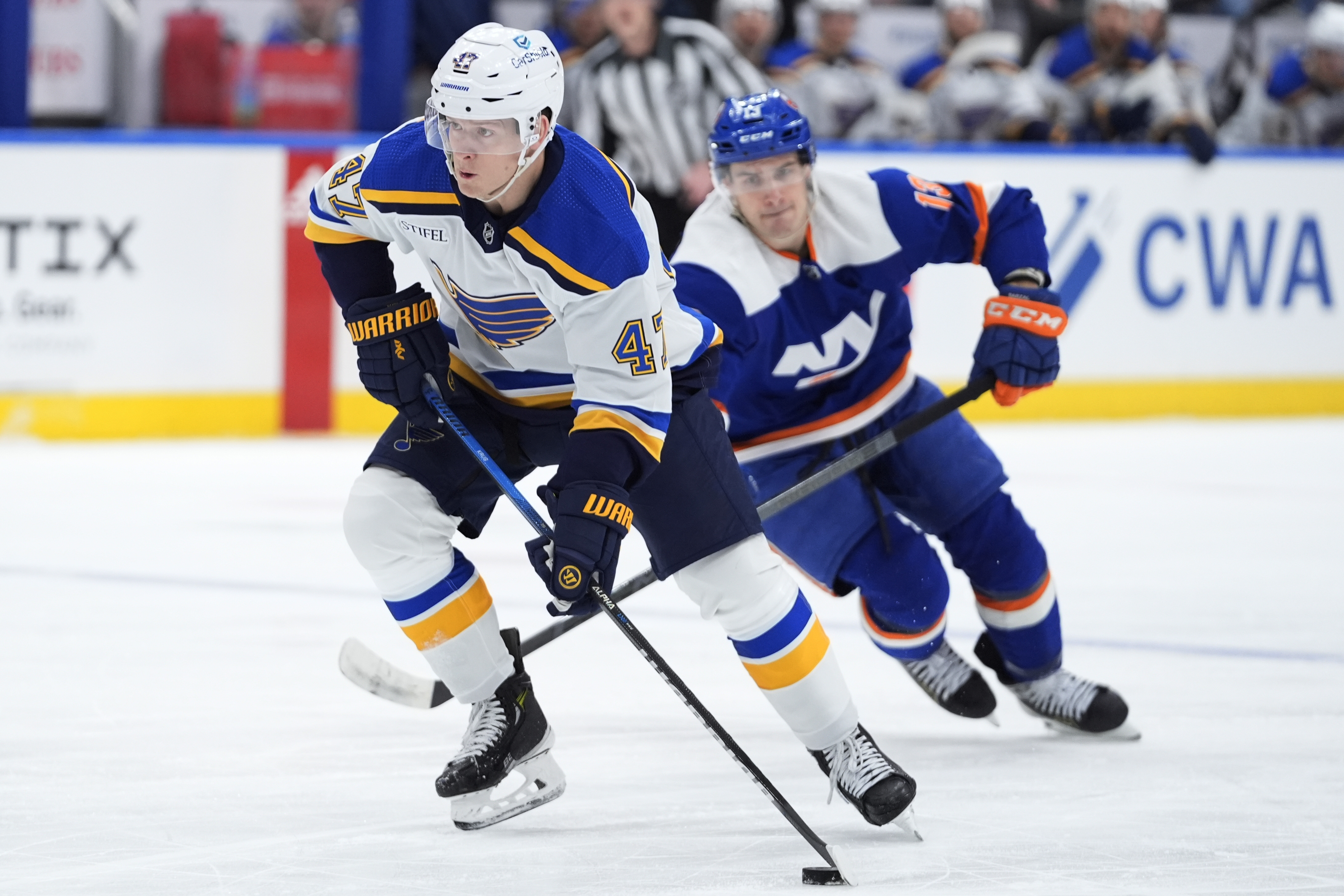 FILE - St. Louis Blues' Torey Krug (47) drives past New York Islanders' Mathew Barzal (13) during the first period of an NHL hockey game, March 5, 2024, in Elmont, N.Y.