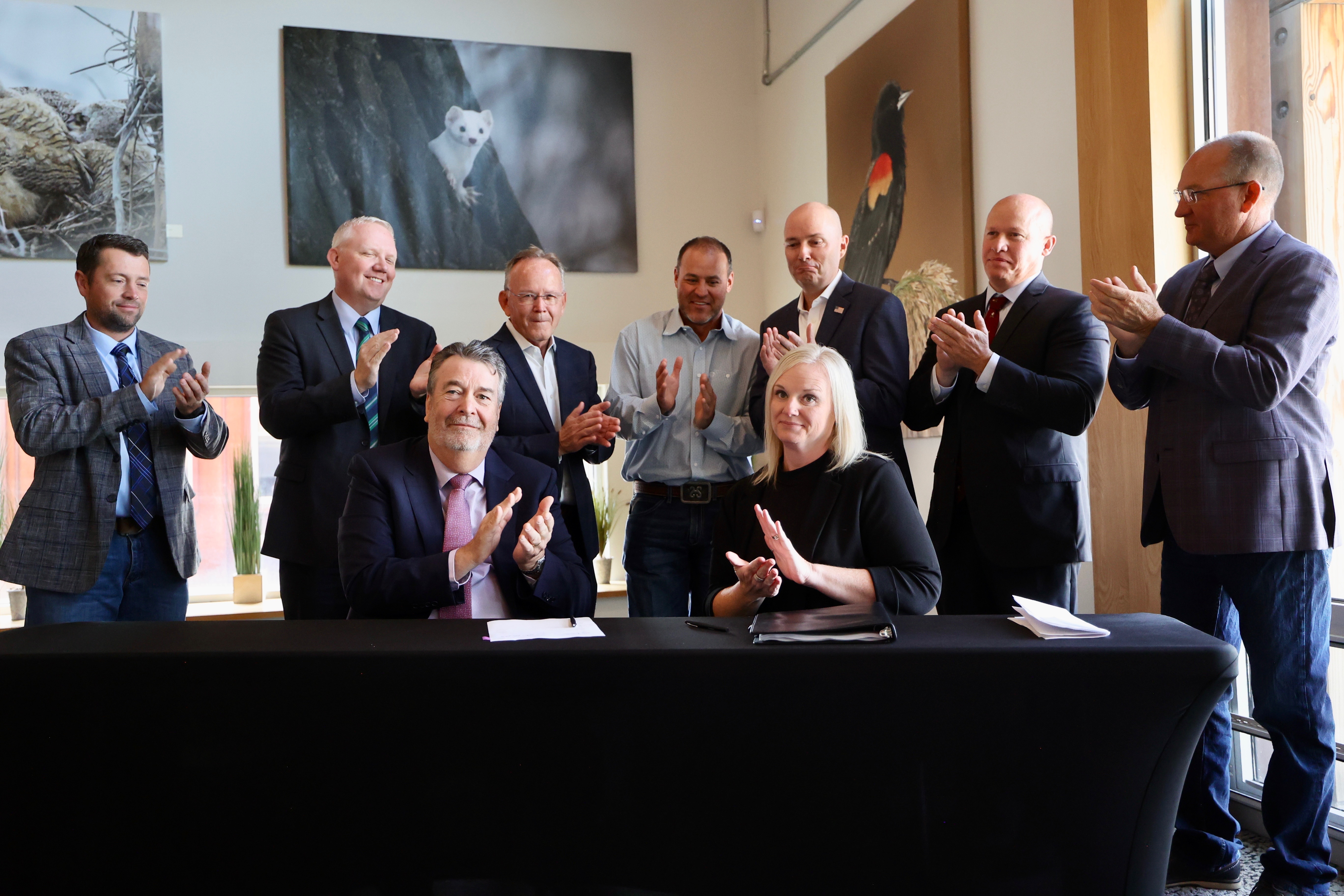 Compass Minerals CEO Edward Dowling, front left, and Utah Forestry, Fire and State Lands Director Jamie Barnes, front right, as well as Utah leaders applaud after a water conservation deal is finalized on Tuesday. The deal includes over 200,000 acre-feet directed to the Great Salt Lake every year, according to the state.